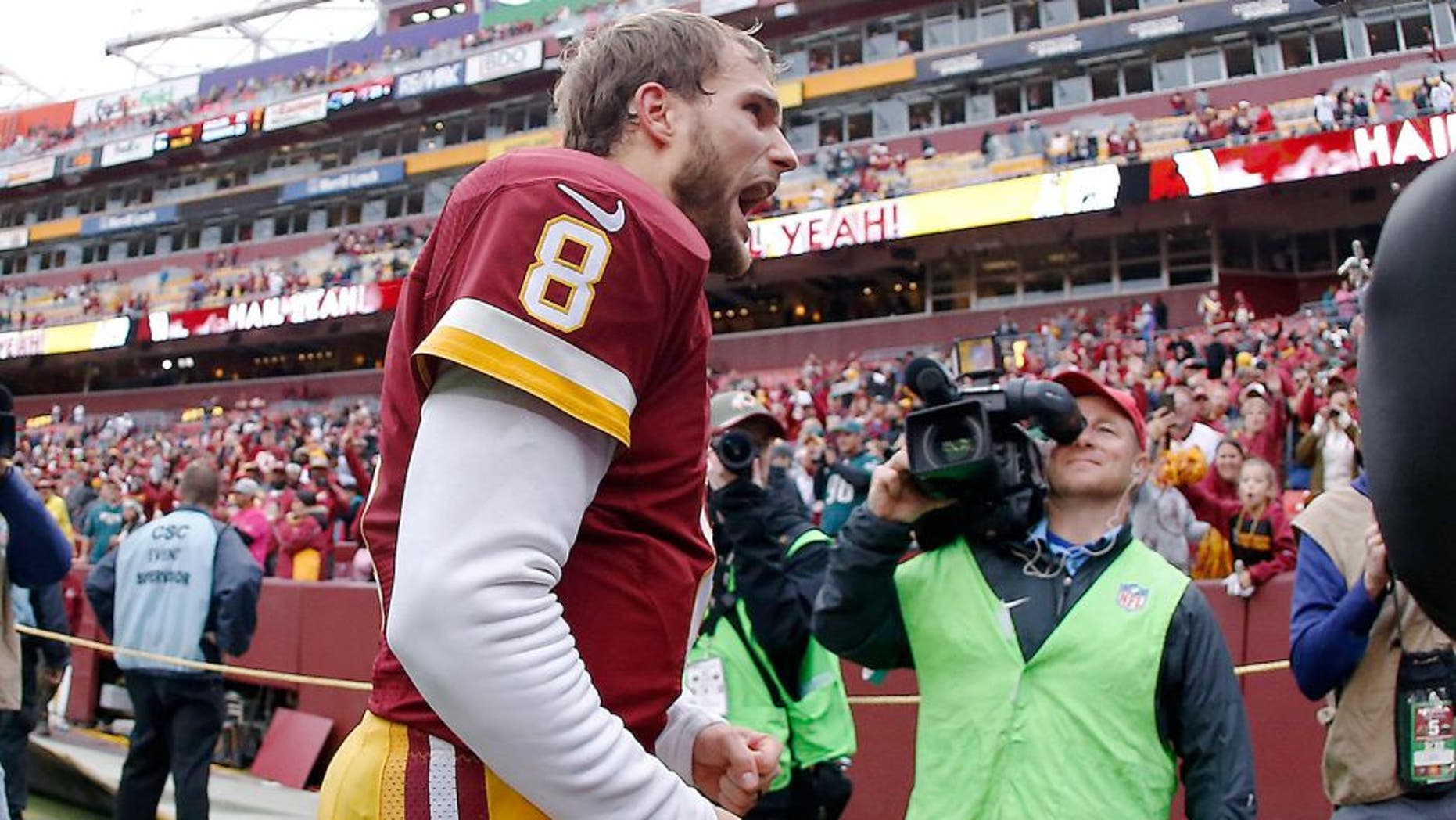 Oct 4, 2015; Landover, MD, USA; Washington Redskins quarterback Kirk Cousins (8) celebrates while leaving the field after the Reskins' game against the Philadelphia Eagles at FedEx Field. The Redskins won 23-20. Mandatory Credit: Geoff Burke-USA TODAY Sports