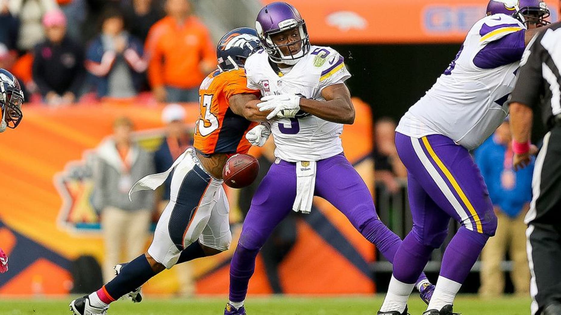 DENVER, CO - OCTOBER 4: Quarterback Teddy Bridgewater #5 of the Minnesota Vikings has the ball stripped by strong safety T.J. Ward #43 of the Denver Broncos to end the game in favor of the Denver Broncos by a score of 23-20 at Sports Authority Field at Mile High on October 4, 2015 in Denver, Colorado. (Photo by Justin Edmonds/Getty Images)