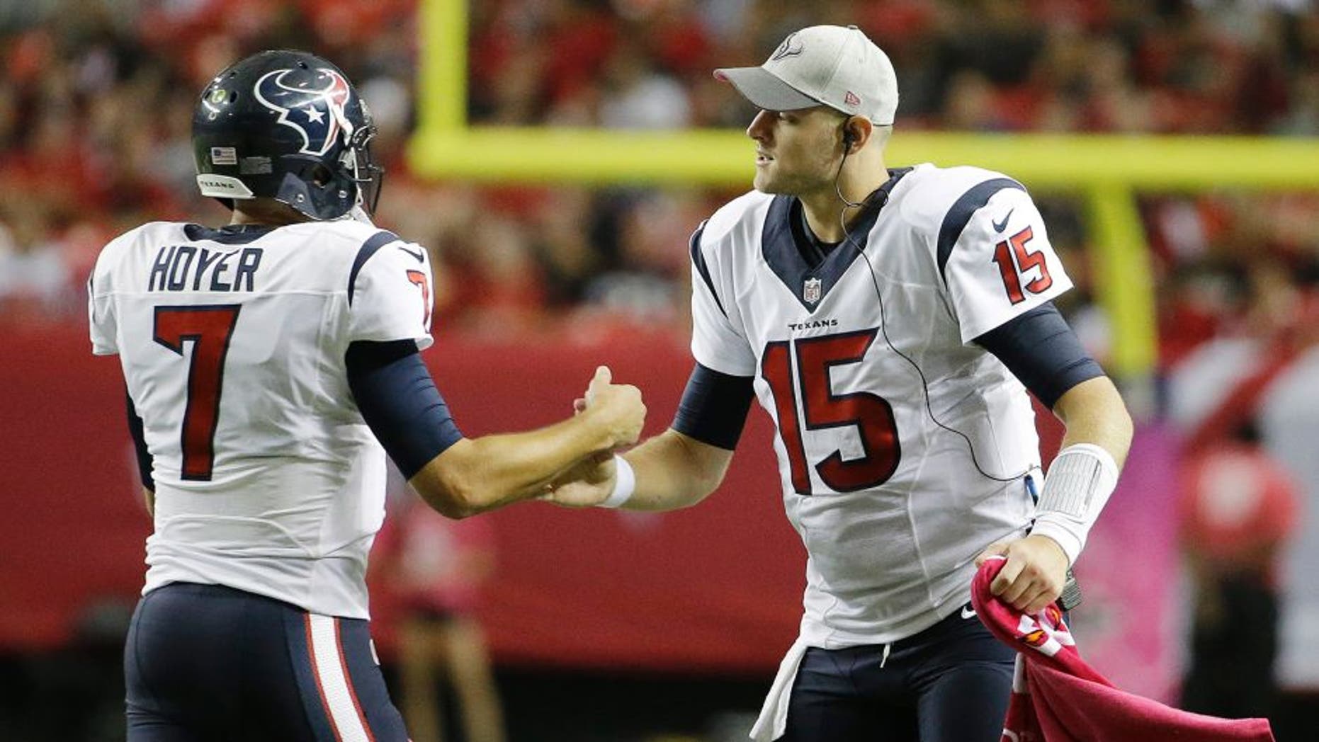 Houston Texans quarterback Ryan Mallett (15) congratulates Houston Texans quarterback Brian Hoyer (7) after Hoyer through a touchdown passs against the Atlanta Falcons during the second half of an NFL football game, Sunday, Oct. 4, 2015, in Atlanta. (AP Photo/David Goldman)