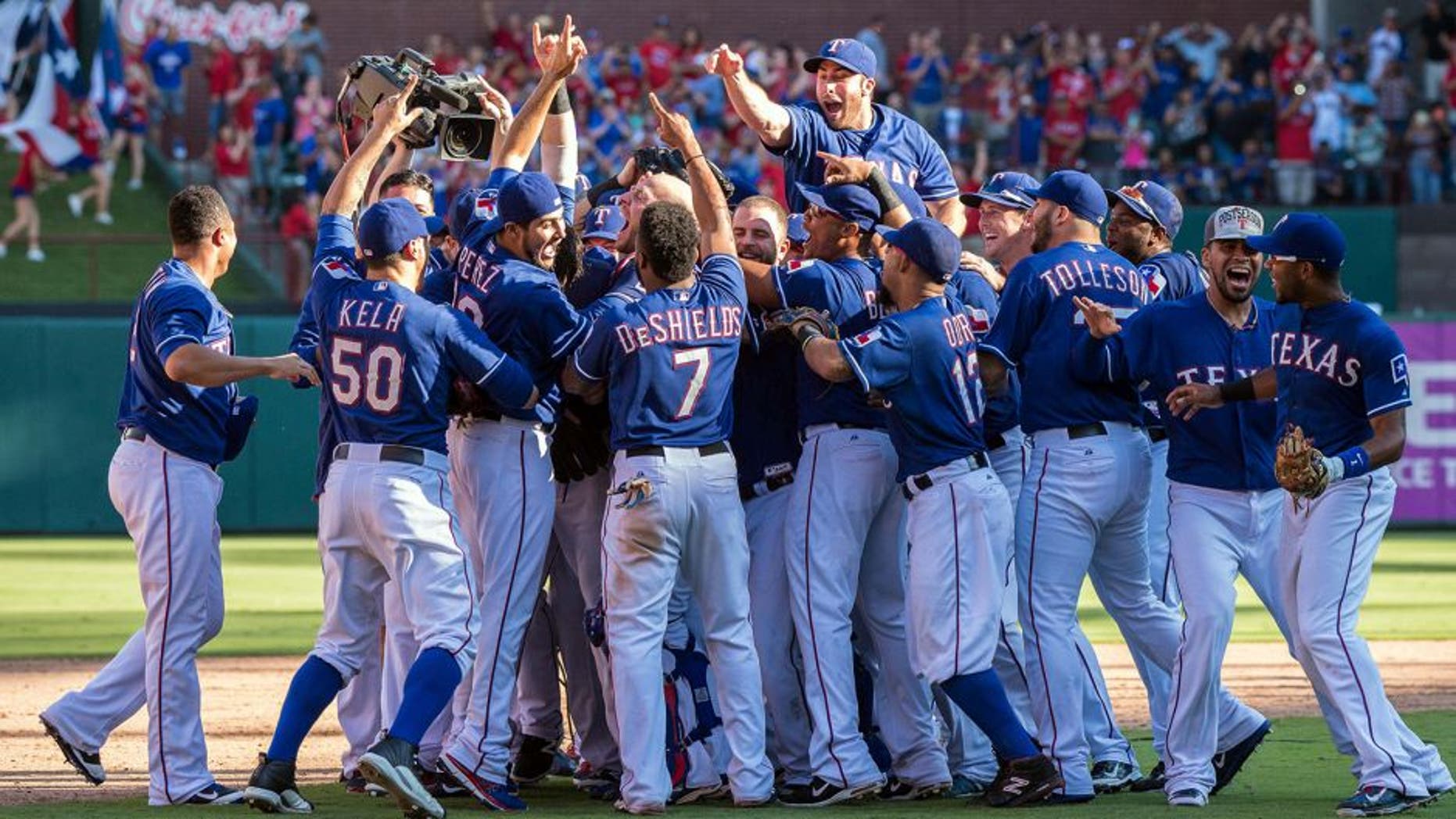 Oct 4, 2015; Arlington, TX, USA; The Texas Rangers celebrate their win over the Los Angeles Angels at Globe Life Park in Arlington. The Texas Rangers defeat the Angels 9-2 and clinch the American League West division. Mandatory Credit: Jerome Miron-USA TODAY Sports