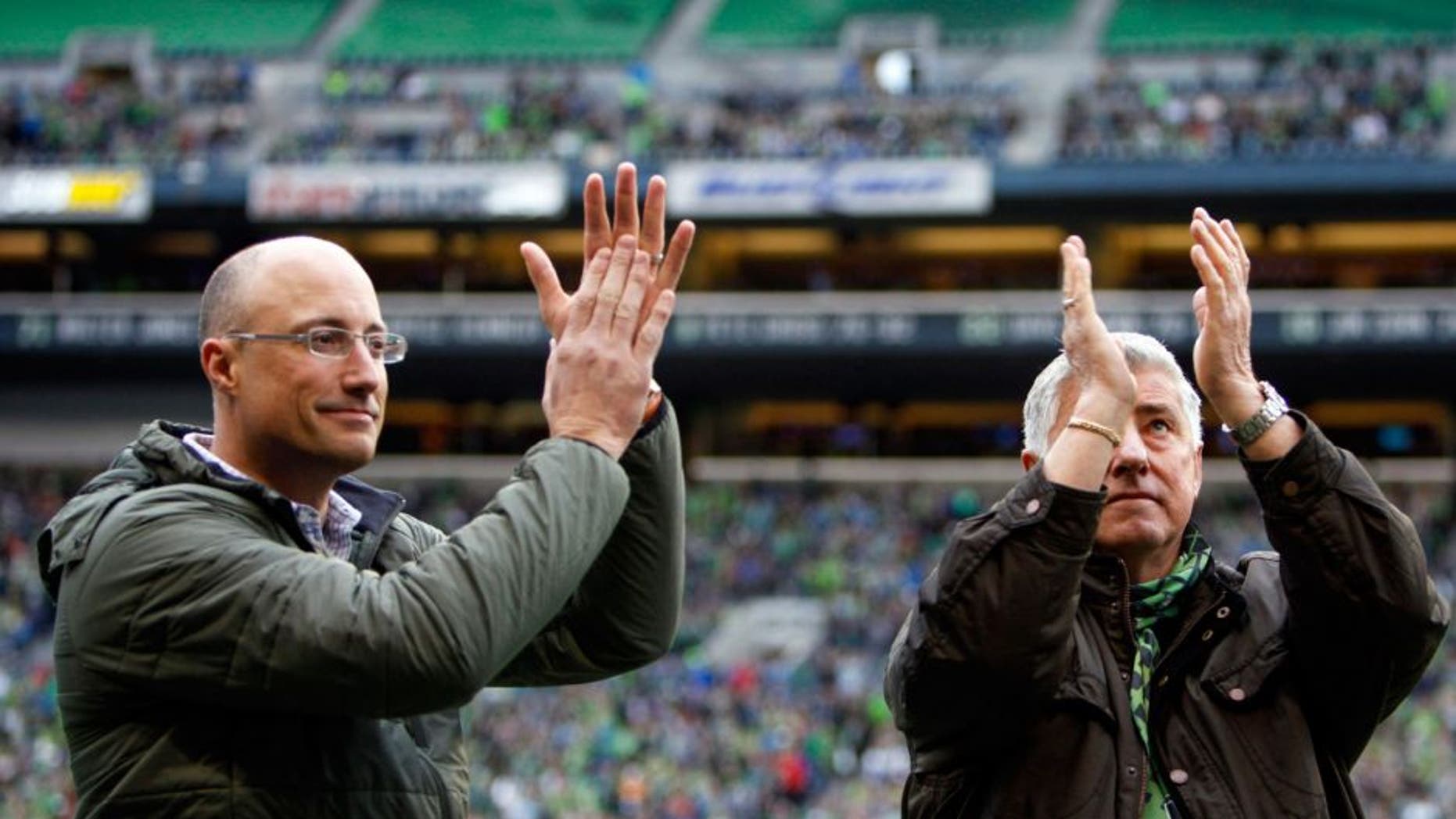 Apr 26, 2015; Seattle, WA, USA; Hall of Fame inductees Seattle Sounders FC head coach Sigi Schmid, right, and Seattle Sounders FC former goalie Kasey Keller applaud the fans before a game against the Portland Timbers at CenturyLink Field. Seattle defeated Portland, 1-0. Mandatory Credit: Joe Nicholson-USA TODAY Sports