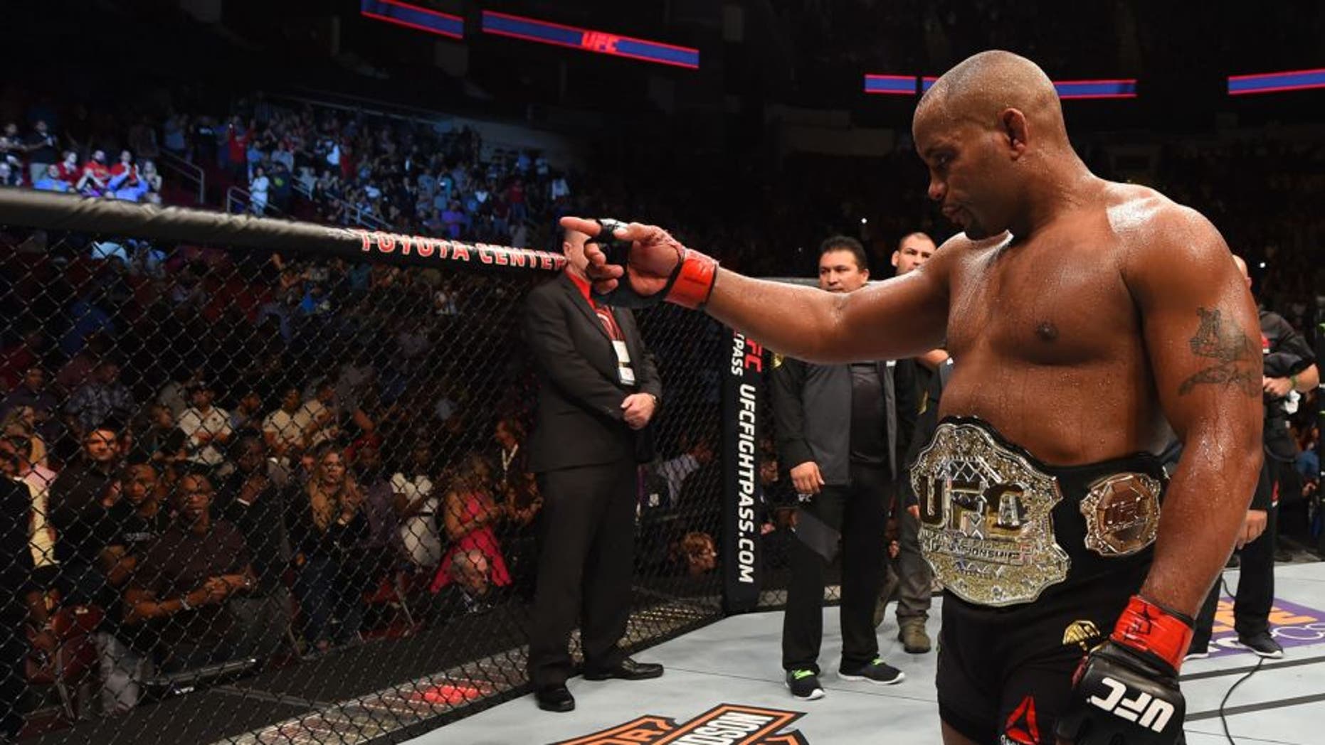HOUSTON, TX - OCTOBER 03: Daniel Cormier celebrates his victory over Alexander Gustafsson in their UFC light heavyweight championship bout during the UFC 192 event at the Toyota Center on October 3, 2015 in Houston, Texas. (Photo by Josh Hedges/Zuffa LLC/Zuffa LLC via Getty Images)