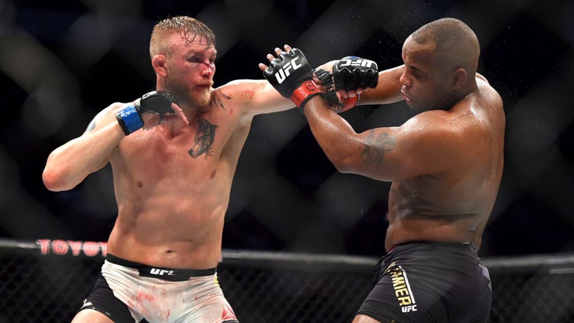 HOUSTON, TX - OCTOBER 03: (L-R) Alexander Gustafsson punches Daniel Cormier in their UFC light heavyweight championship bout during the UFC 192 event at the Toyota Center on October 3, 2015 in Houston, Texas. (Photo by Jeff Bottari/Zuffa LLC/Zuffa LLC via Getty Images)