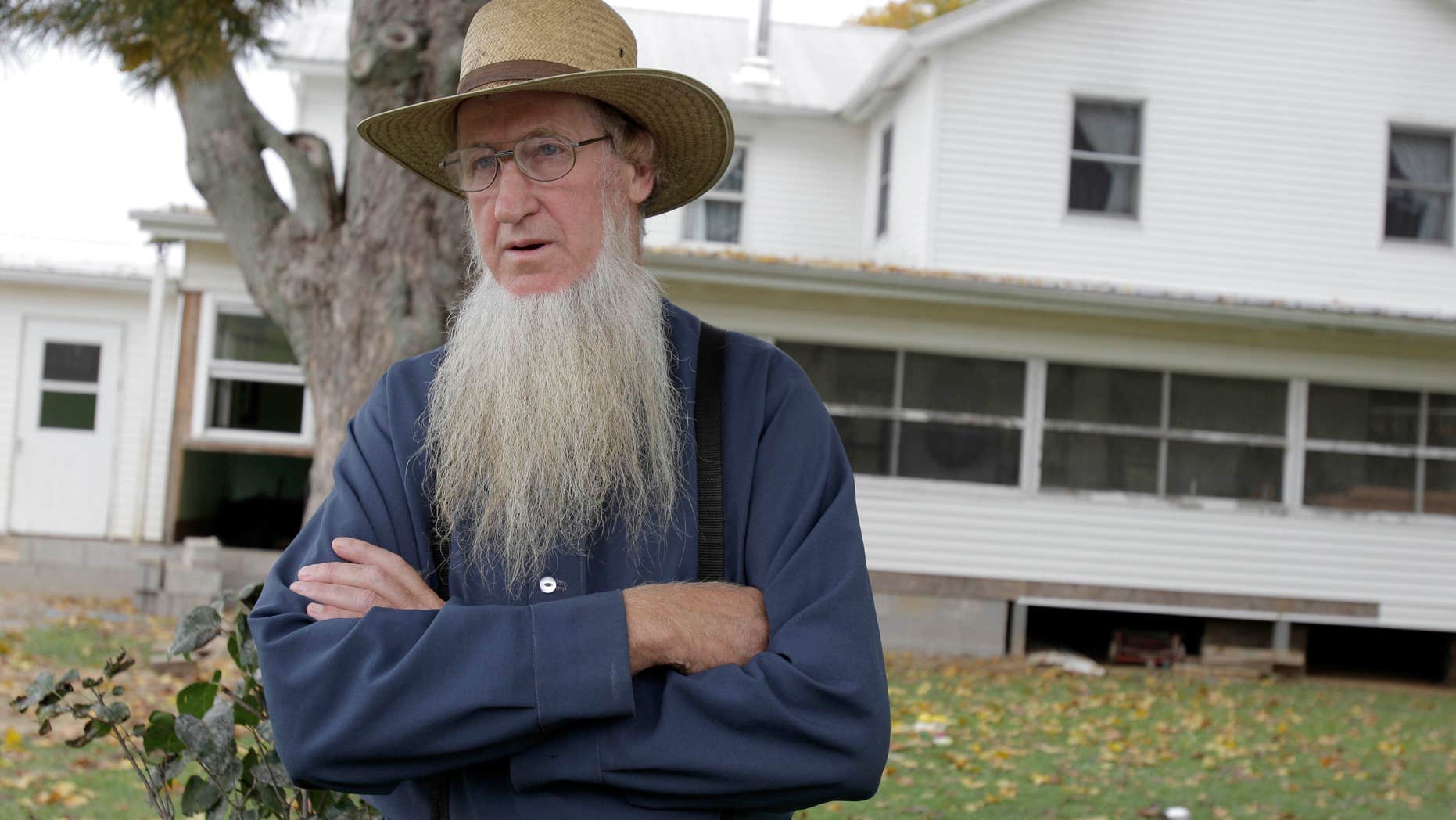 FILE - In this Oct. 10, 2011, file photo, Samuel Mullet Sr. stands in front of his home in Bergholz, Ohio.