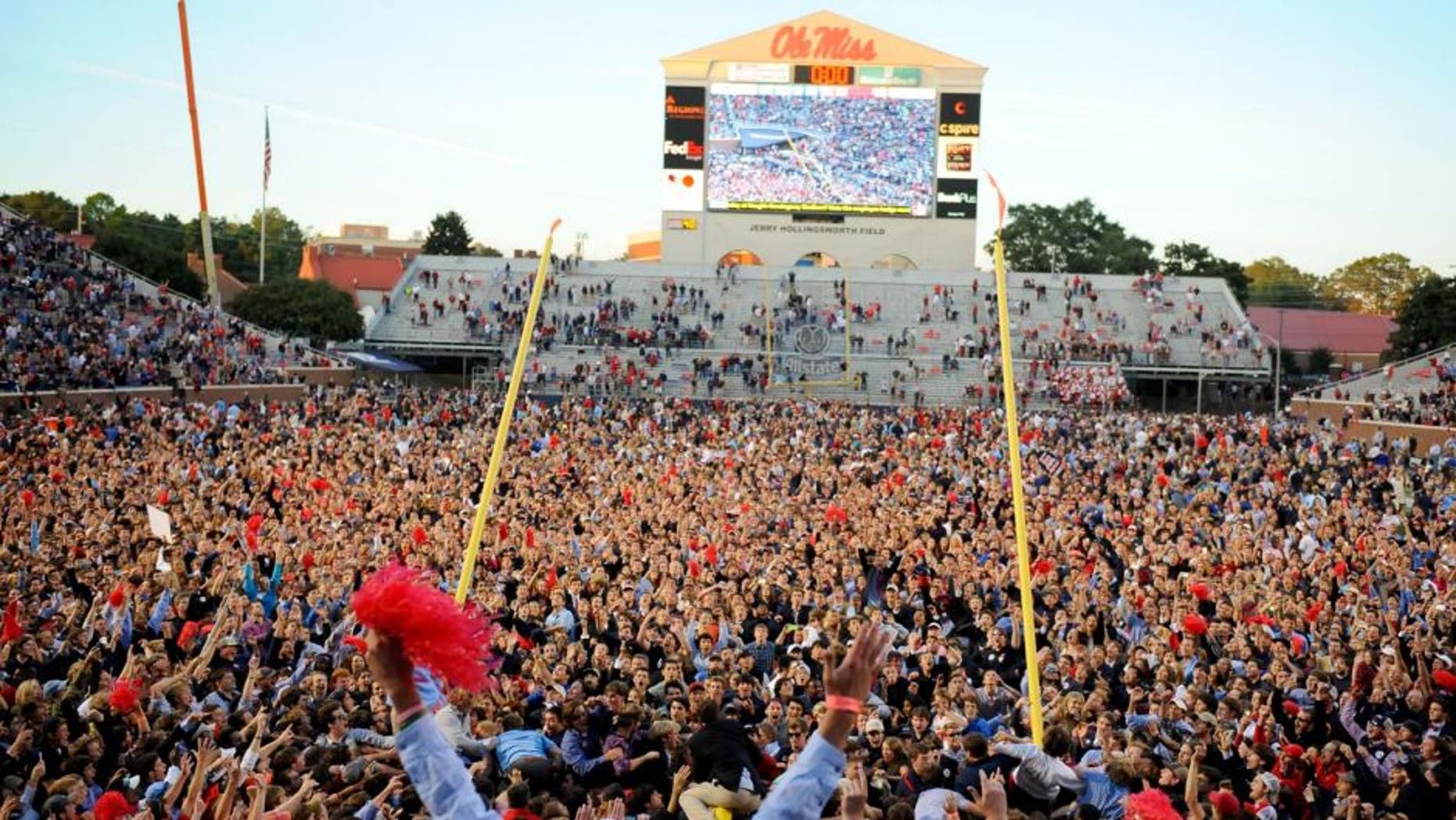 Oct 4, 2014; Oxford, MS, USA; Mississippi Rebels fans tear down the goal posts after a win against the Alabama Crimson Tide at Vaught-Hemingway Stadium. The Rebels won 23-17. Mandatory Credit: Christopher Hanewinckel-USA TODAY Sports