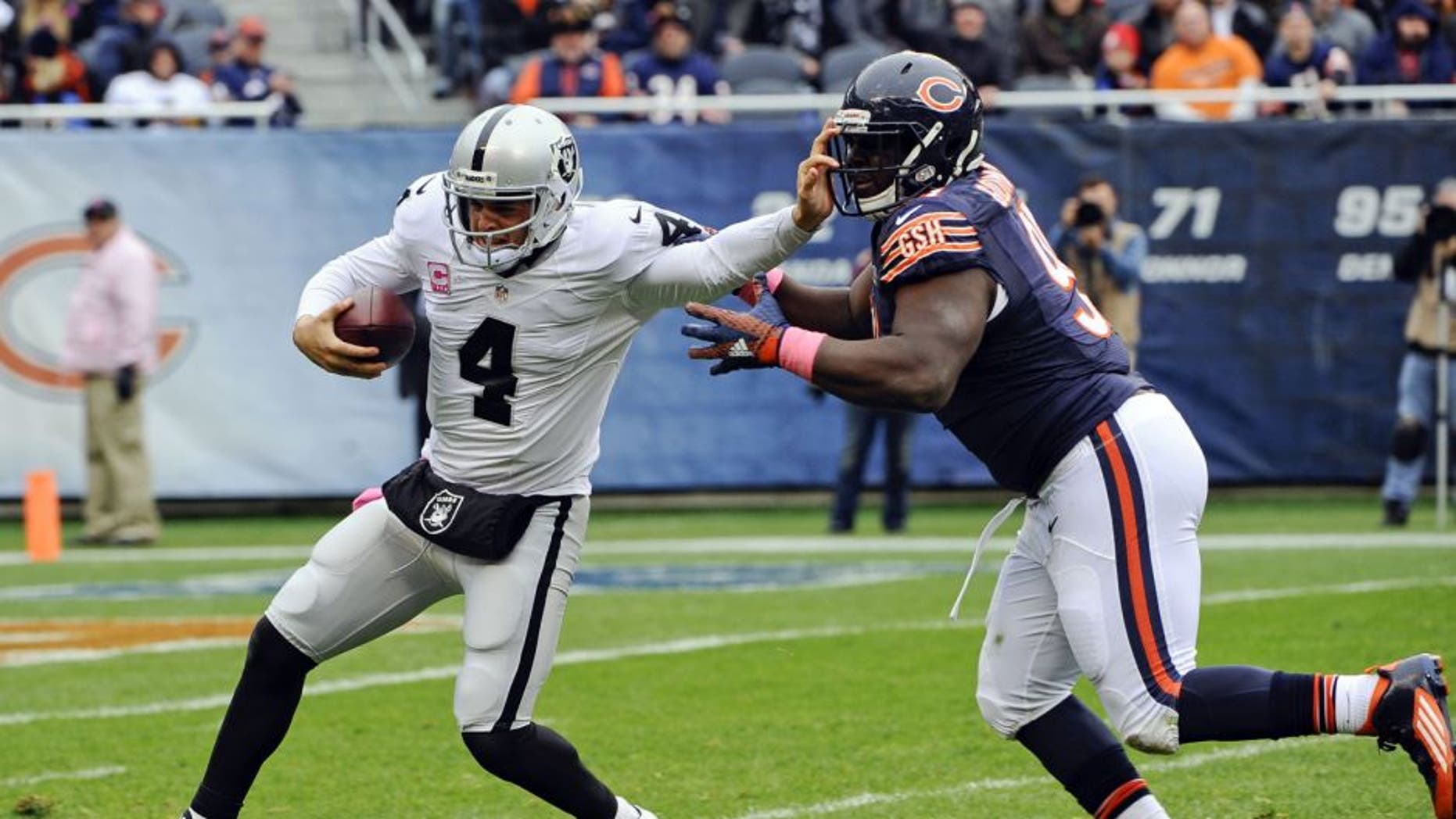 Oct 4, 2015; Chicago, IL, USA; Oakland Raiders quarterback Derek Carr (4) is sacked by Chicago Bears nose tackle Eddie Goldman (91) in the first half at Soldier Field. Mandatory Credit: Matt Marton-USA TODAY Sports
