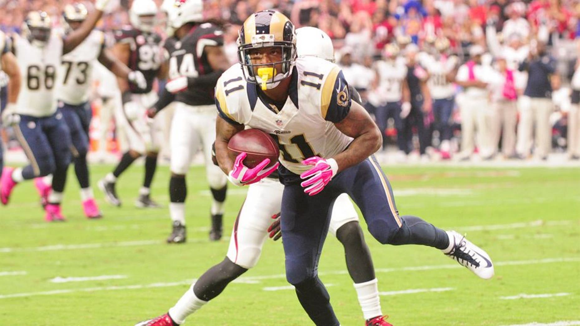 Oct 4, 2015; Glendale, AZ, USA; St. Louis Rams wide receiver Tavon Austin (11) breaks a tackle from Arizona Cardinals free safety Tyrann Mathieu (32) to score a 12 yard touchdown during the first half at University of Phoenix Stadium. Mandatory Credit: Matt Kartozian-USA TODAY Sports