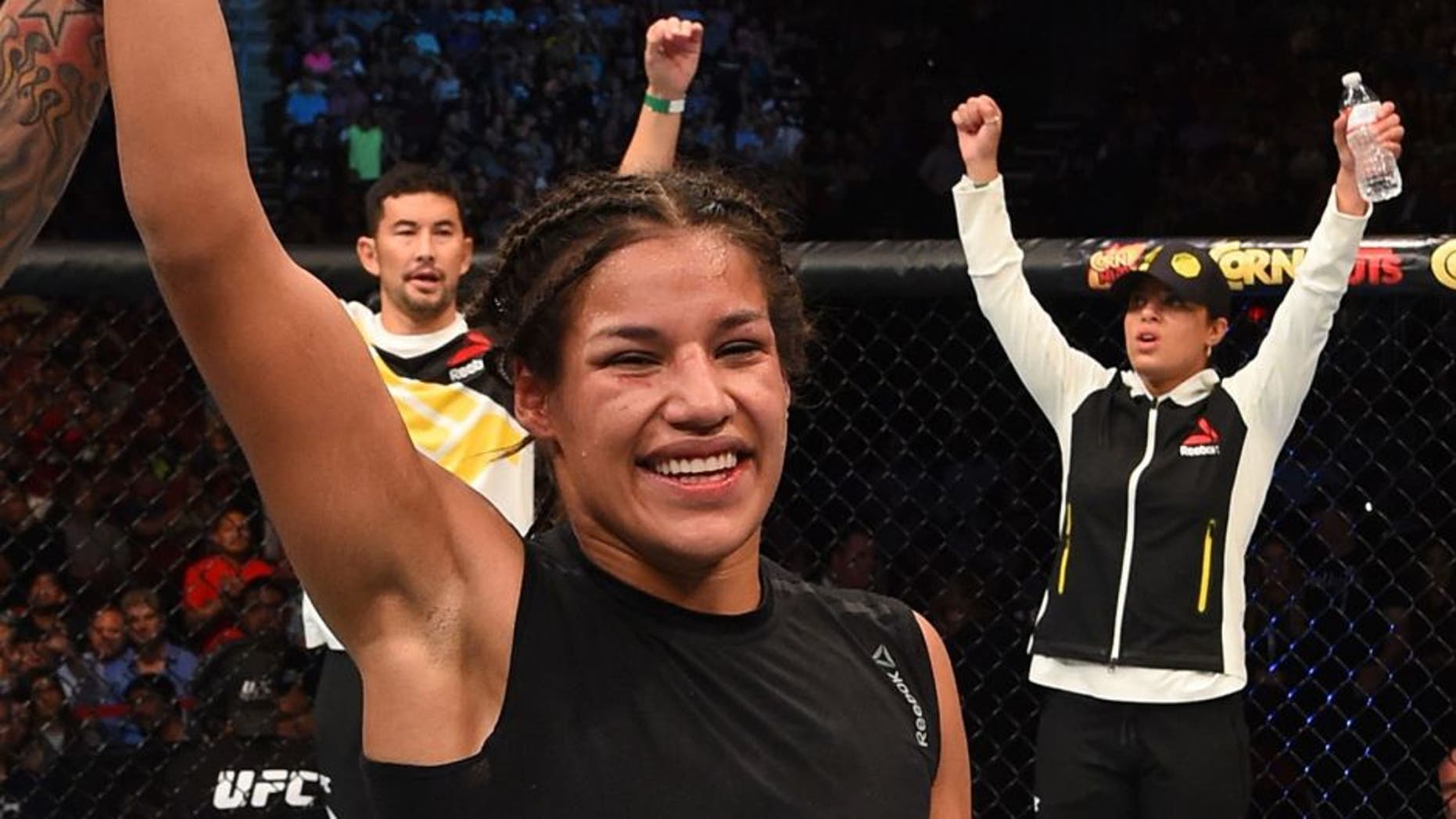 HOUSTON, TX - OCTOBER 03: Julianna Pena exchanges celebrates her victory over Jessica Eye in their women's bantamweight bout during the UFC 192 event at the Toyota Center on October 3, 2015 in Houston, Texas. (Photo by Josh Hedges/Zuffa LLC/Zuffa LLC via Getty Images)