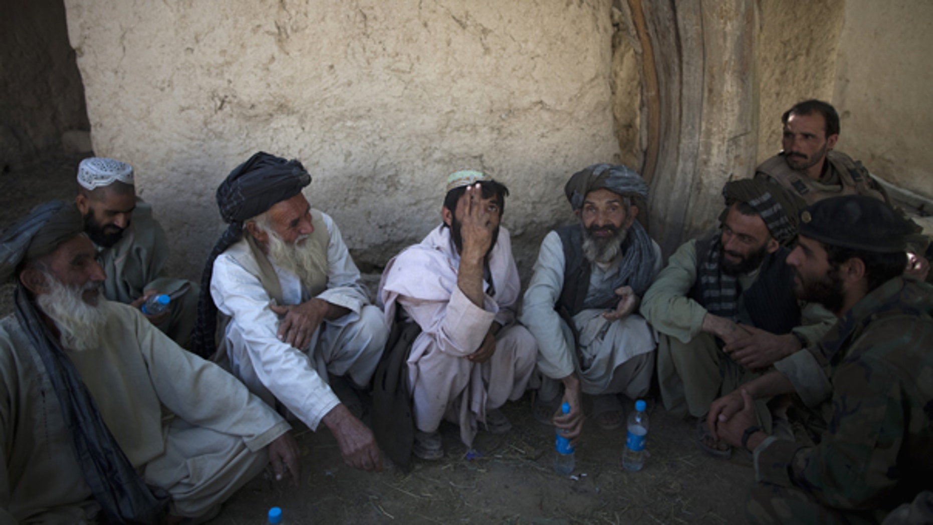 Oct. 6: Local residents meet with Afghan and U.S. soldiers to discuss security at an outpost near Forward Operation Base Howz-e-Madad, Zhari district, Kandahar province, Afghanistan.