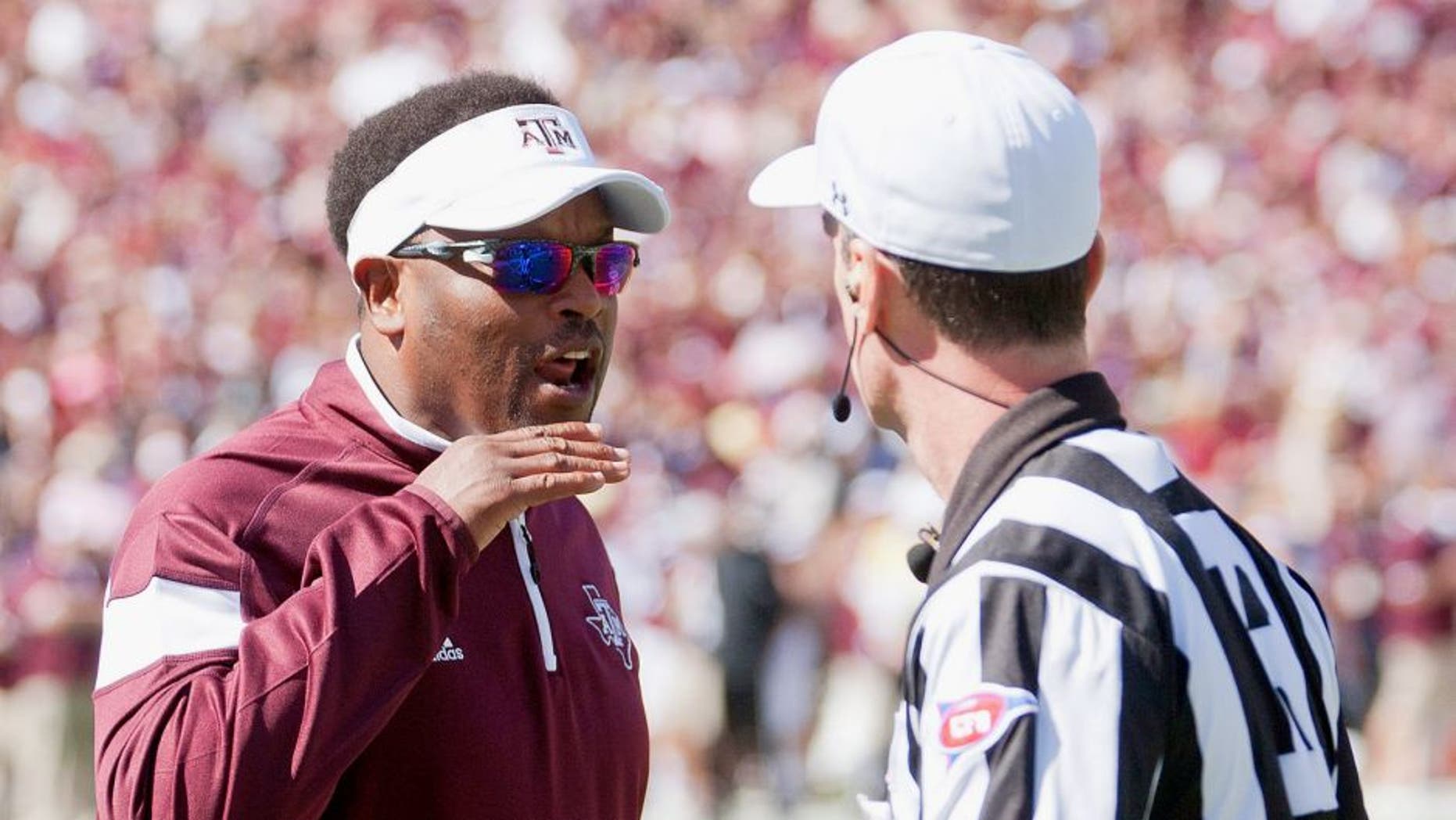 Oct 4, 2014; Starkville, MS, USA; Texas A&M Aggies head coach Kevin Sumlin discusses a play with an official during the game against the Mississippi State Bulldogs at Davis Wade Stadium. Mandatory Credit: Marvin Gentry-USA TODAY Sports