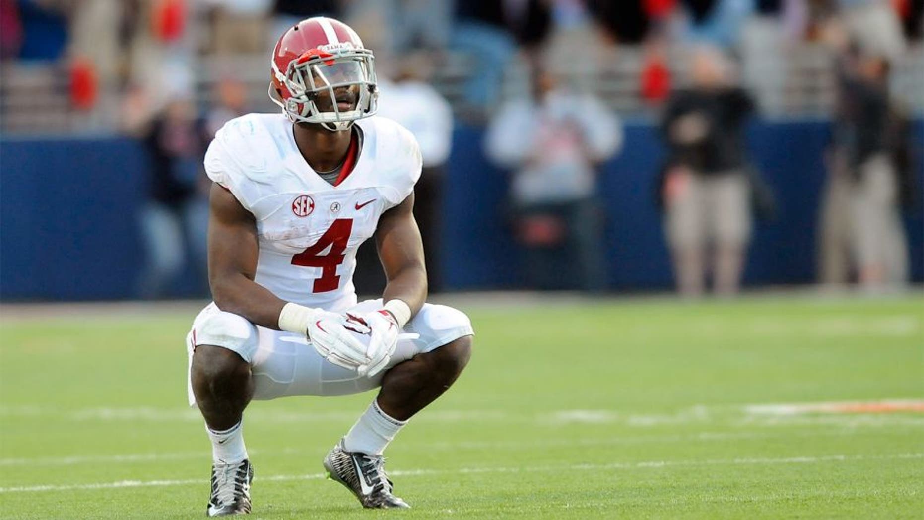 Oct 4, 2014; Oxford, MS, USA; Alabama Crimson Tide running back T.J. Yeldon (4) reacts while watching a replay of an interception in the end zone was overturned during the second half against the Mississippi Rebels at Vaught-Hemingway Stadium. The Rebels won 23-17. Mandatory Credit: Christopher Hanewinckel-USA TODAY Sports