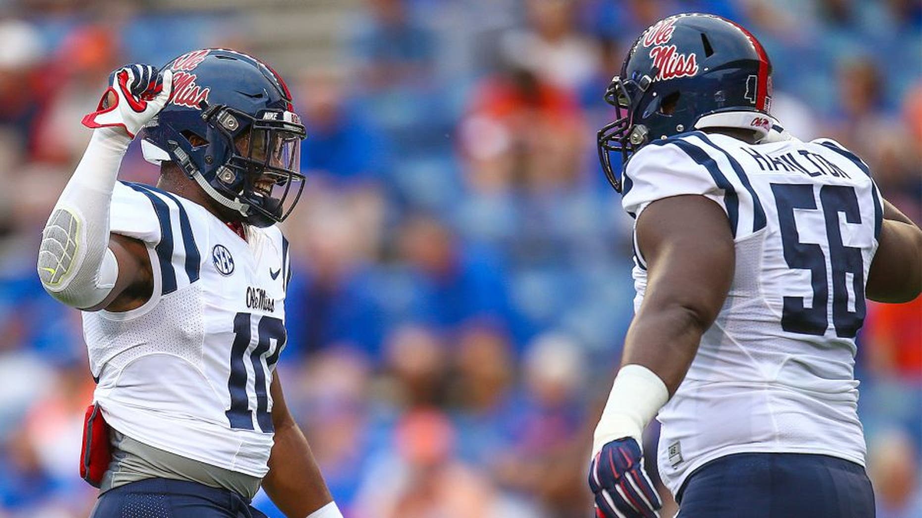 GAINESVILLE, FL - OCTOBER 03: C.J. Johnson #10 of the Mississippi Rebels slaps hands with Woodrow Hamilton #56 of the Mississippi Rebels before the game against the Florida Gators on October 3, 2015 in Gainesville, Florida. (Photo by Rob Foldy/Getty Images)