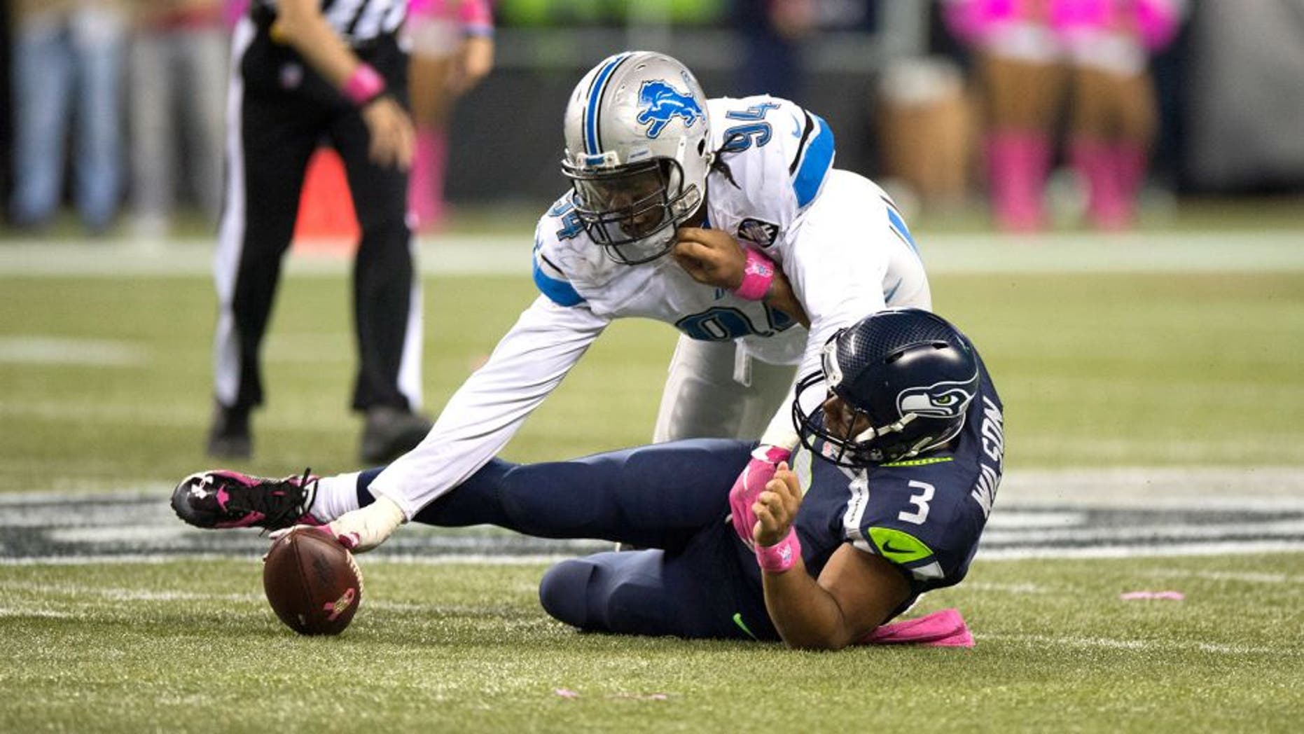 Oct 5, 2015; Seattle, WA, USA; Detroit Lions defensive end Ezekiel Ansah (94) recovers a fumble after sacking Seattle Seahawks quarterback Russell Wilson (3) during the fourth quarter at CenturyLink Field. The Seahawks won 13-10. Mandatory Credit: Troy Wayrynen-USA TODAY Sports