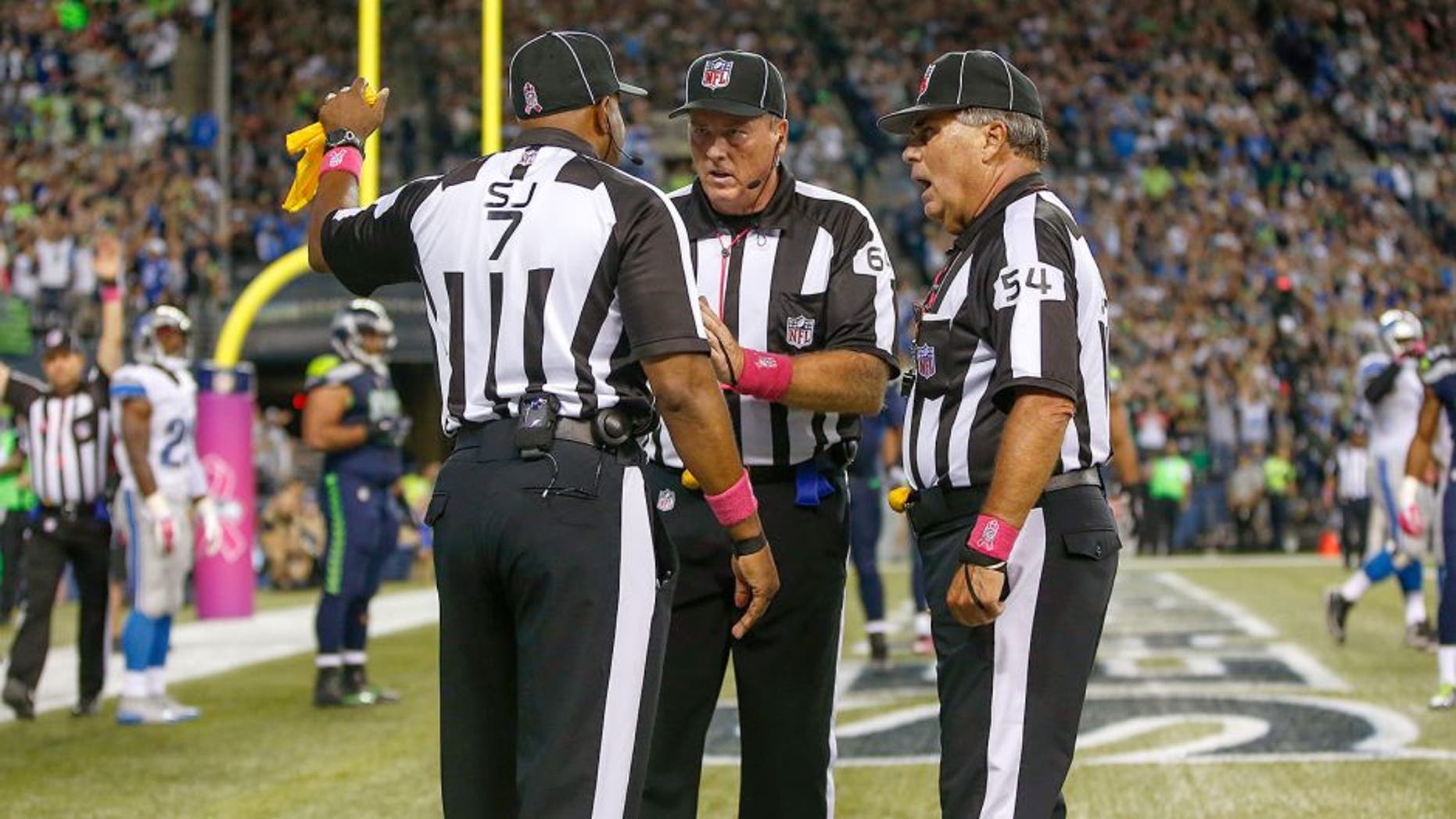 SEATTLE, WA - OCTOBER 05: Referees confer after the ball was batted out of the end zone by outside linebacker K.J. Wright of the Seattle Seahawks following a fumble by wide receiver Calvin Johnson of the Detroit Lions in the fourth quarter at CenturyLink Field on October 5, 2015 in Seattle, Washington. The Seahawks defeated the Lions 13-10. (Photo by Otto Greule Jr/Getty Images)