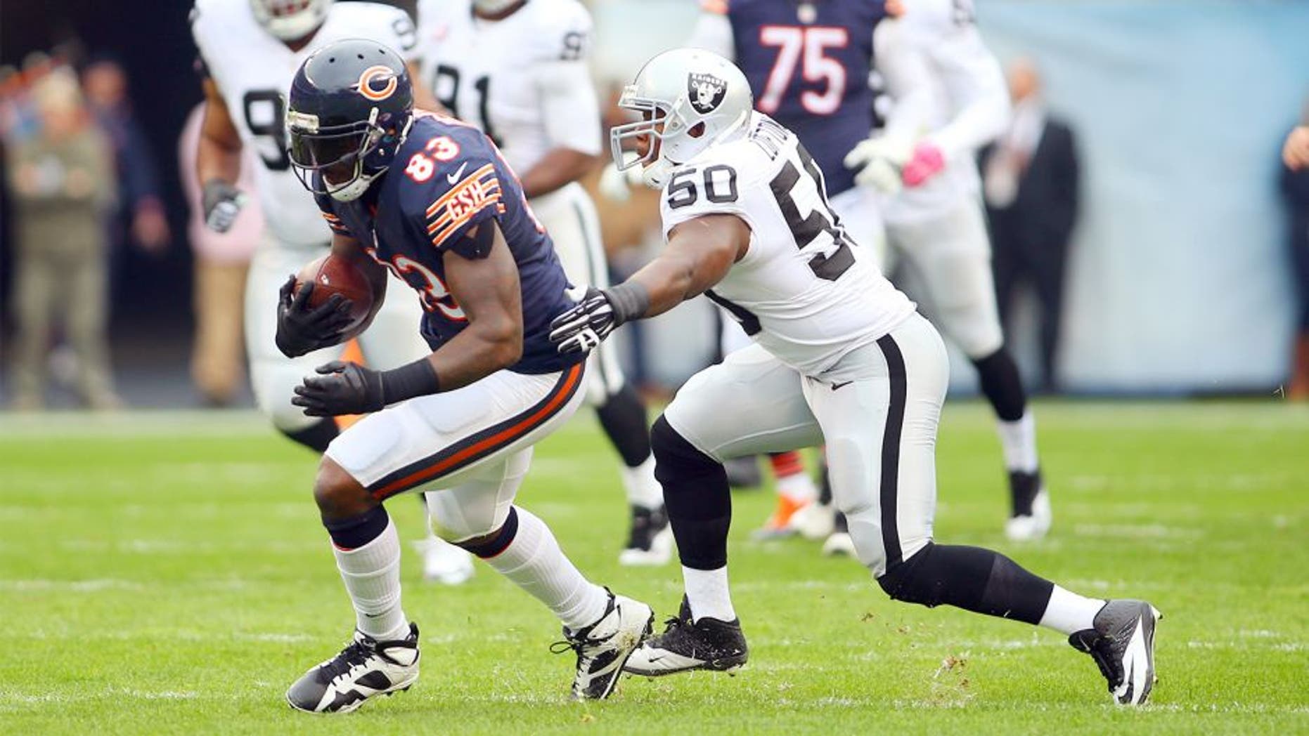 Oct 4, 2015; Chicago, IL, USA; Chicago Bears tight end Martellus Bennett (83) is tackled by Oakland Raiders middle linebacker Curtis Lofton (50) during the first quarter at Soldier Field. Mandatory Credit: Jerry Lai-USA TODAY Sports