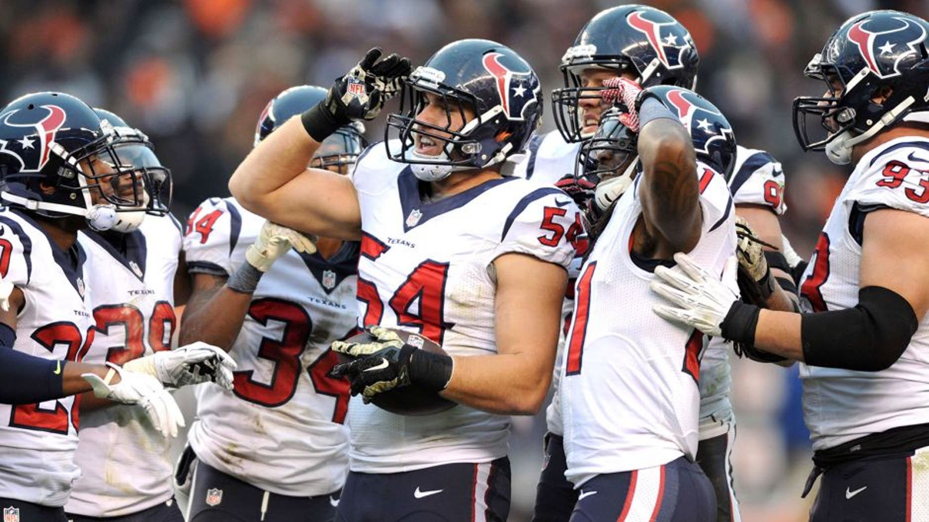 Nov 16, 2014; Cleveland, OH, USA; Houston Texans inside linebacker Mike Mohamed (54) and the Texans defense celebrates his fourth quarter interception against the Cleveland Browns at FirstEnergy Stadium. The Texans beat the Browns 23-7. Mandatory Credit: Ken Blaze-USA TODAY Sports