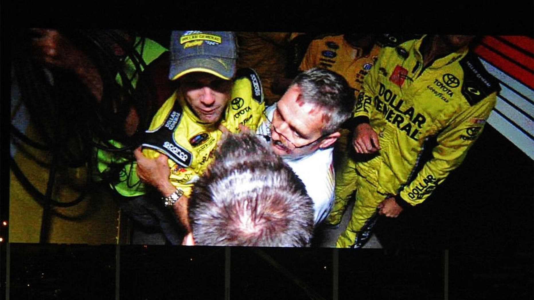 NASCAR Sprint Cup Series driver Matt Kenseth is involved in fisticuffs between haulers following the the Bank of America 500 in an image shown on the video display board at Charlotte Motor Speedway in Concord, N.C., on Saturday, Oct. 11, 2014. (Jeff Siner/Charlotte Observer/MCT)