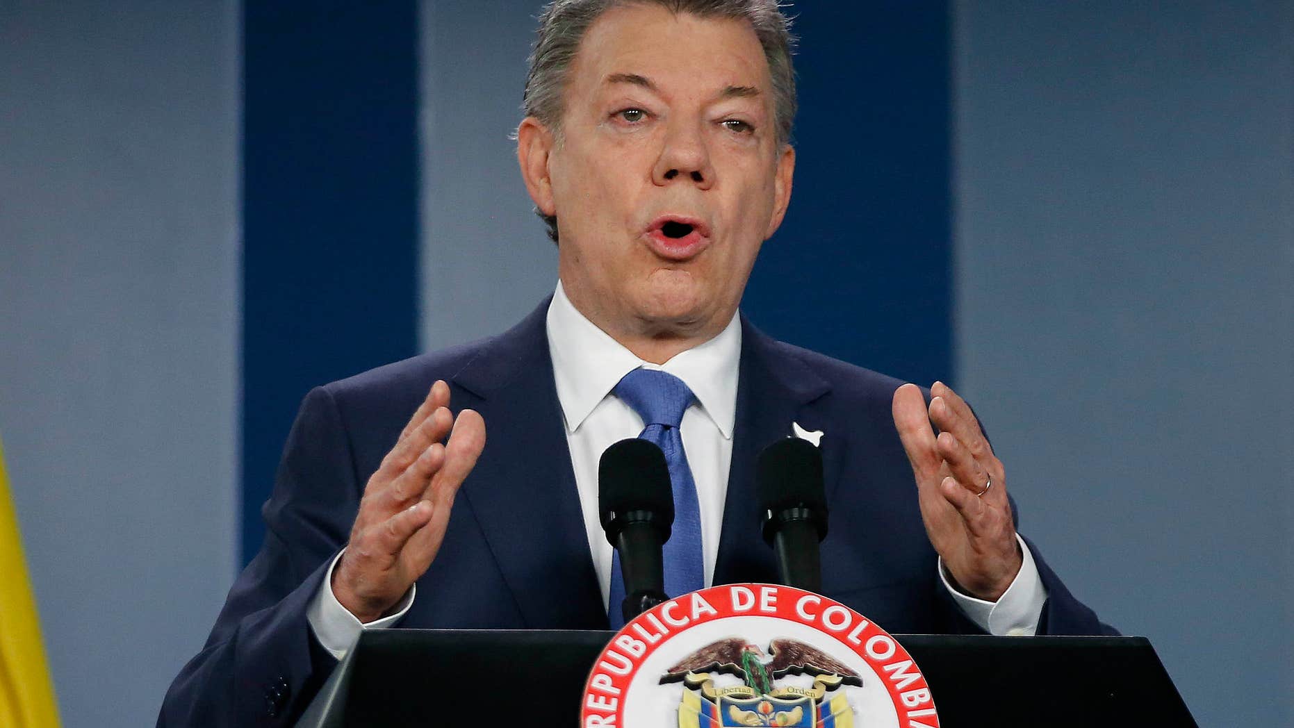 FILE - In this Wednesday, Oct. 4, 2016 file photo, Colombia’s President Juan Manuel Santos delivers a statement to the press after meeting with former President Alvaro Uribe and other opposition leaders at the presidential palace in Bogota, Colombia.