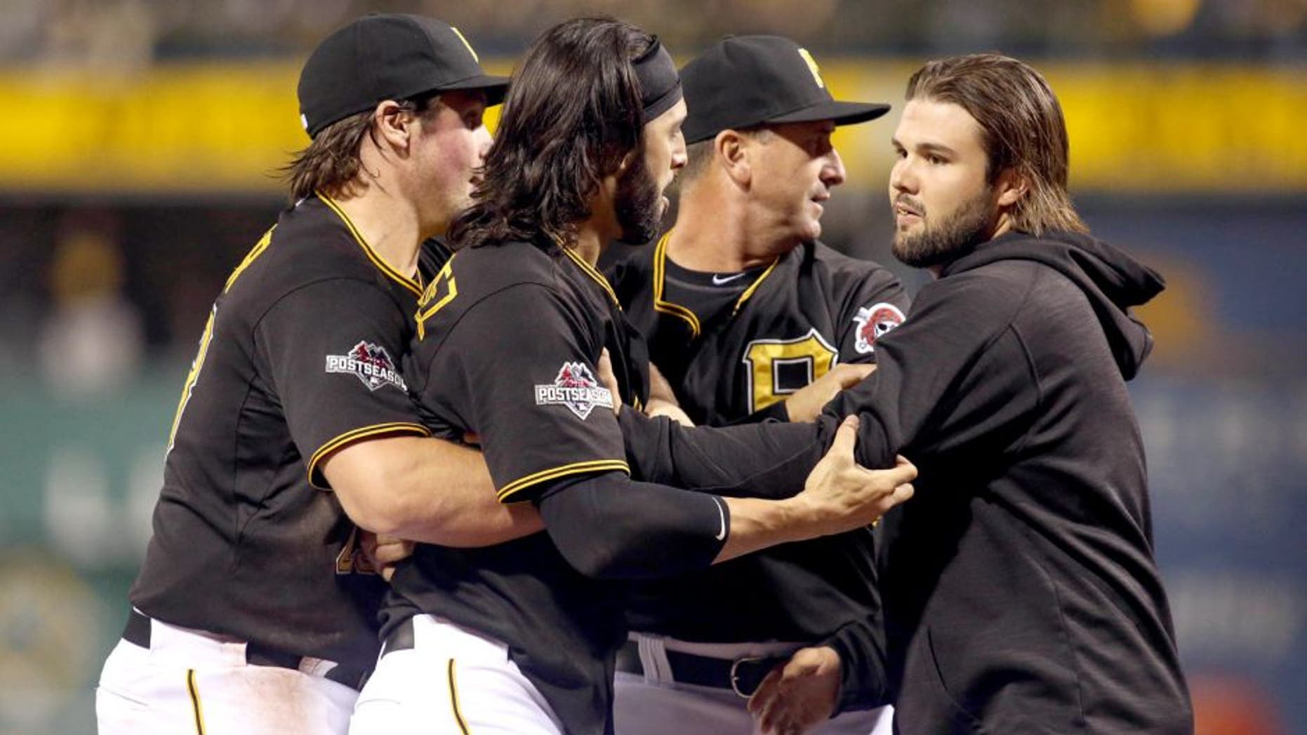 Oct 7, 2015; Pittsburgh, PA, USA; Pittsburgh Pirates first baseman Sean Rodriguez (3) is held back by teammates during an altercation with the Chicago Cubs during the seventh inning in the National League Wild Card playoff baseball game at PNC Park. Rodriguez was ejected from the game. Mandatory Credit: Charles LeClaire-USA TODAY Sports