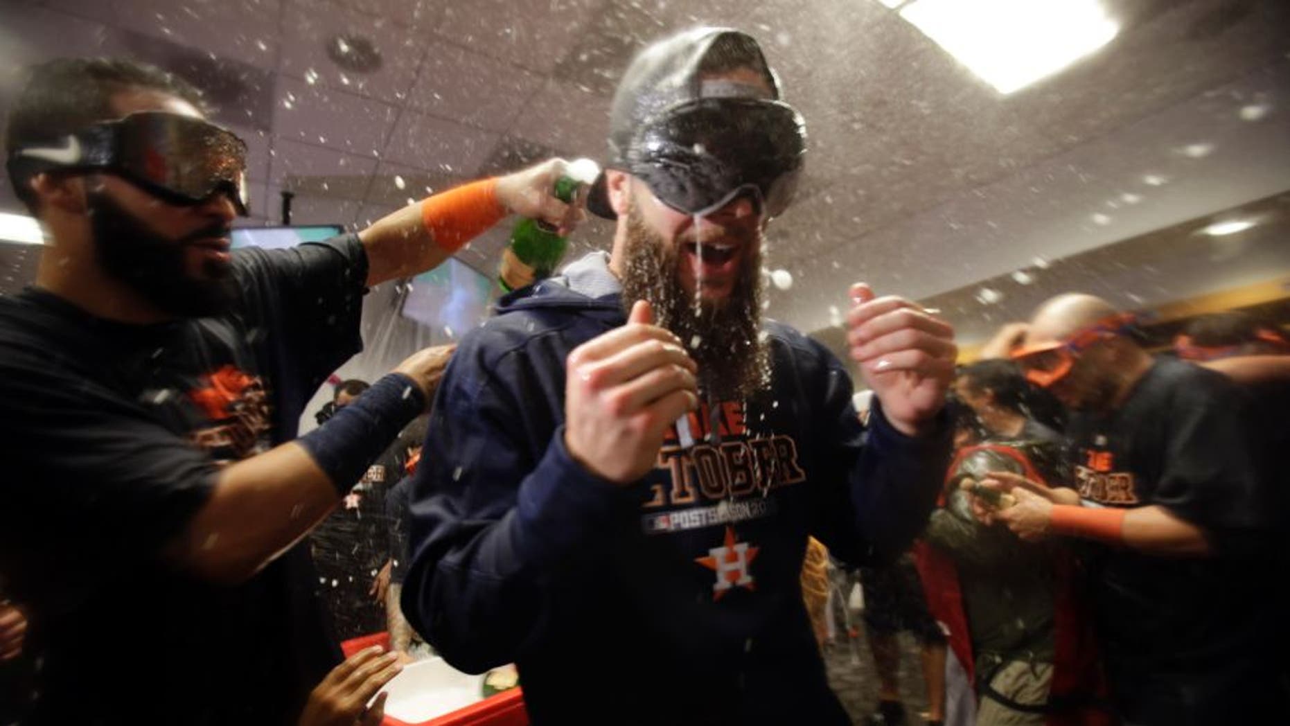 Oct 6, 2015; Bronx, NY, USA; Houston Astros starting pitcher Dallas Keuchel (right) celebrates with teammates in the locker room after defeating the New York Yankees in the American League Wild Card playoff baseball game at Yankee Stadium. Houston won 3-0. Mandatory Credit: Adam Hunger-USA TODAY Sports