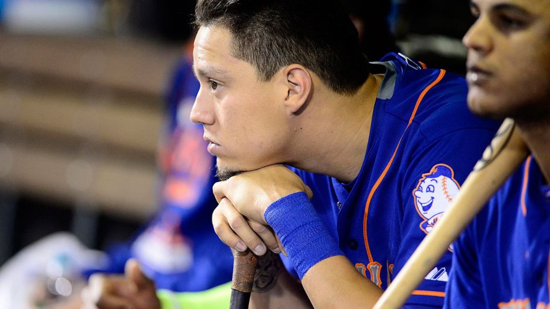 Aug 22, 2015; Denver, CO, USA; New York Mets shortstop Wilmer Flores (4) in his dugout in the ninth inning against the Colorado Rockies at Coors Field. The Mets defeated the Rockies 14-9. Mandatory Credit: Ron Chenoy-USA TODAY Sports