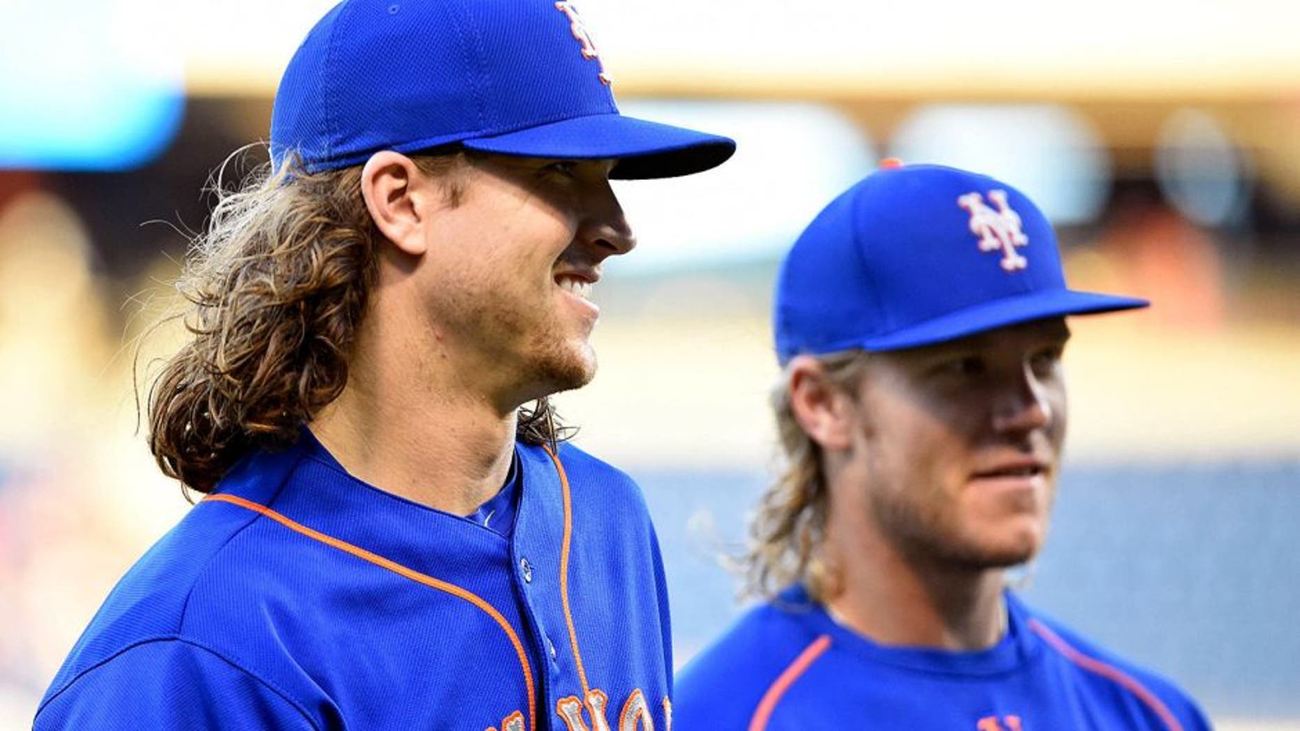 Aug 27, 2015; Philadelphia, PA, USA; New York Mets starting pitcher Jacob deGrom (48) and starting pitcher Noah Syndergaard (34) walk toward the dugout before game against the Philadelphia Phillies at Citizens Bank Park. The Mets defeated the Phillies, 9-5 in 13 innings. Mandatory Credit: Eric Hartline-USA TODAY Sports