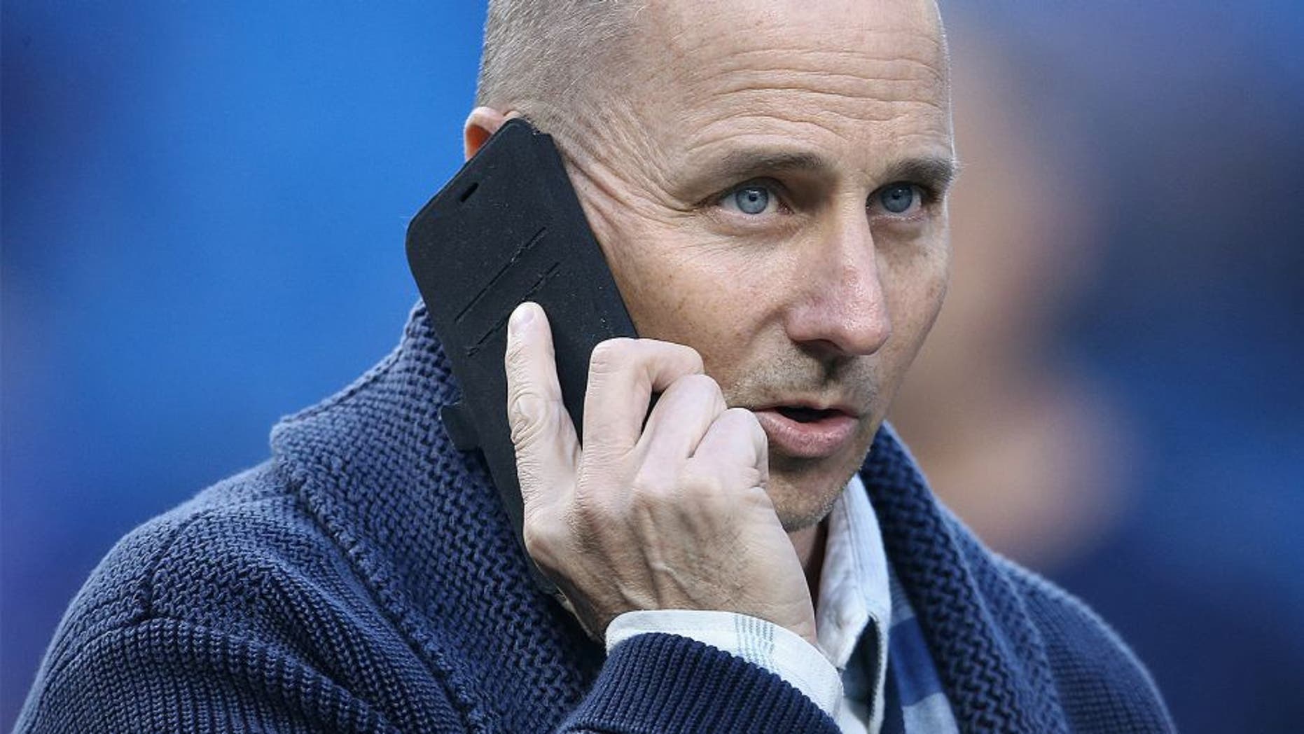 TORONTO, CANADA - SEPTEMBER 21: General manager Brian Cashman of the New York Yankees talks on the phone during batting practice before the start of MLB game action against the Toronto Blue Jays on September 21, 2015 at Rogers Centre in Toronto, Ontario, Canada. (Photo by Tom Szczerbowski/Getty Images)
