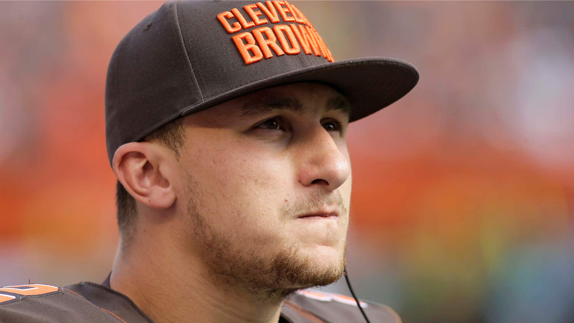 FILE - In this Sept. 27, 2015, file photo, Cleveland Browns quarterback Johnny Manziel watches from the sidelines during the second half of an NFL football game against the Oakland Raiders in Cleveland.