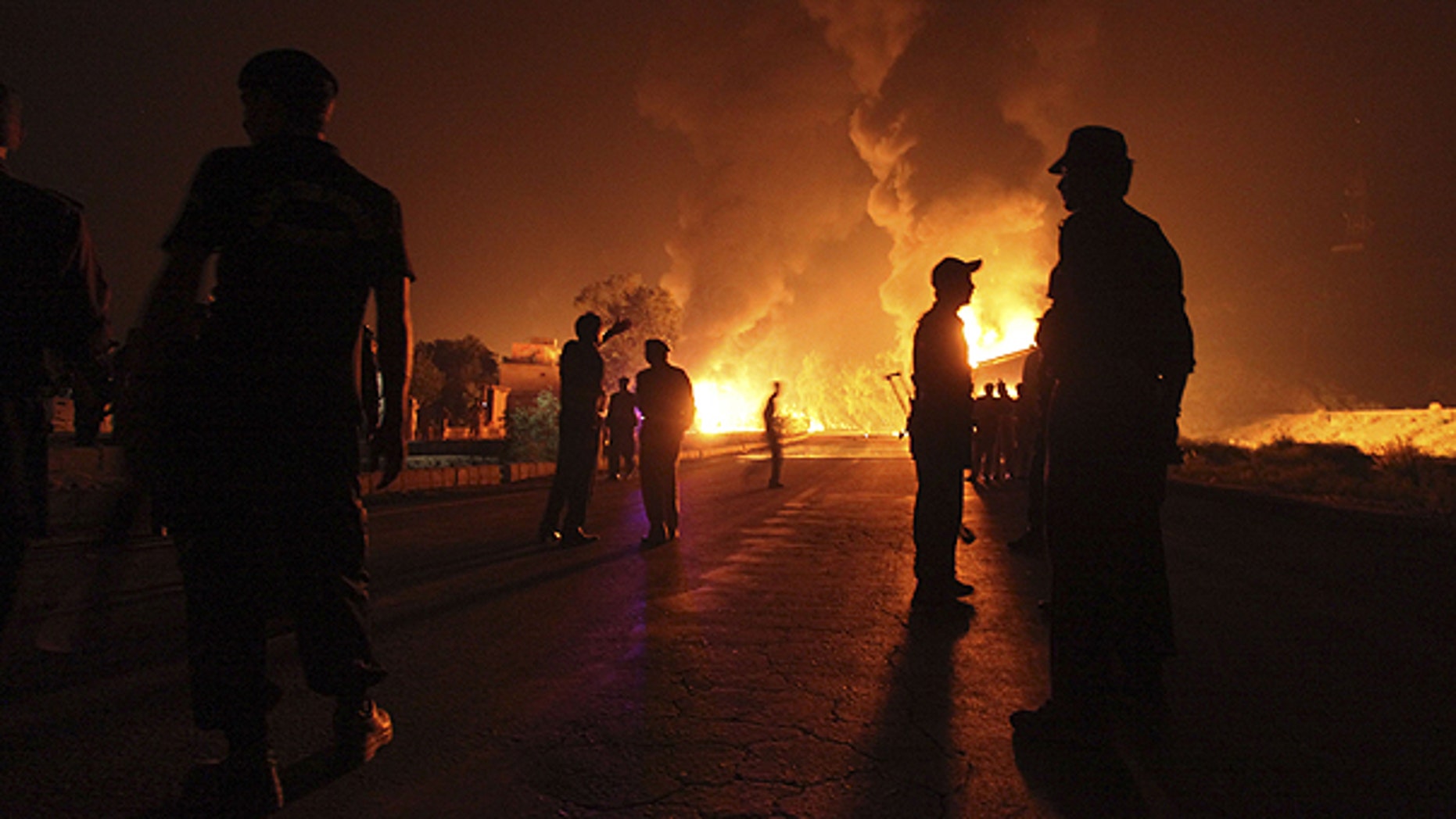 Oct. 6: Pakistani soldiers stand near burning NATO oil tanker allegedly attacked by militants in Nowshera near Peshawar, Pakistan. Gunmen attacked 29 more tankers just before dawn on Oct. 9. In the area of Mithri, about 120 mles east of Quetta, the capital of Baluchistan province.