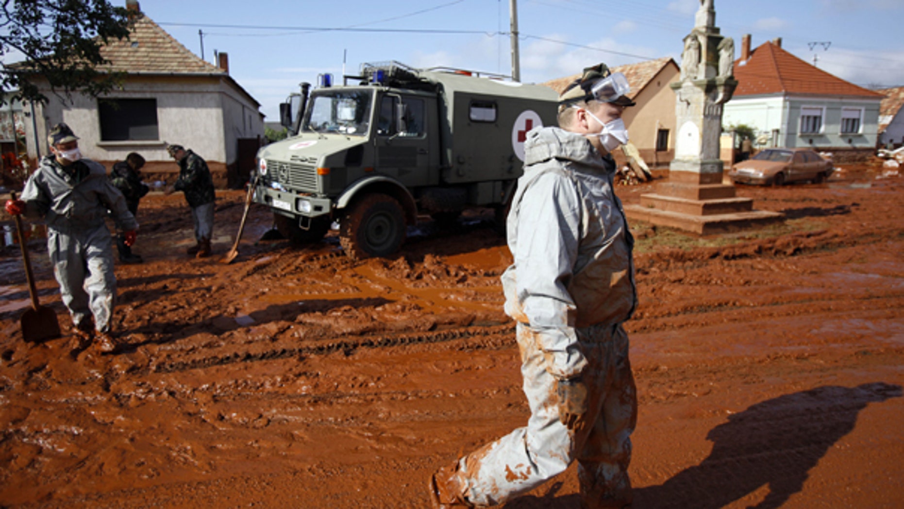 Oct. 7: A Hungarian soldier walks through a street flooded by toxic mud in Devecser, Hungary.