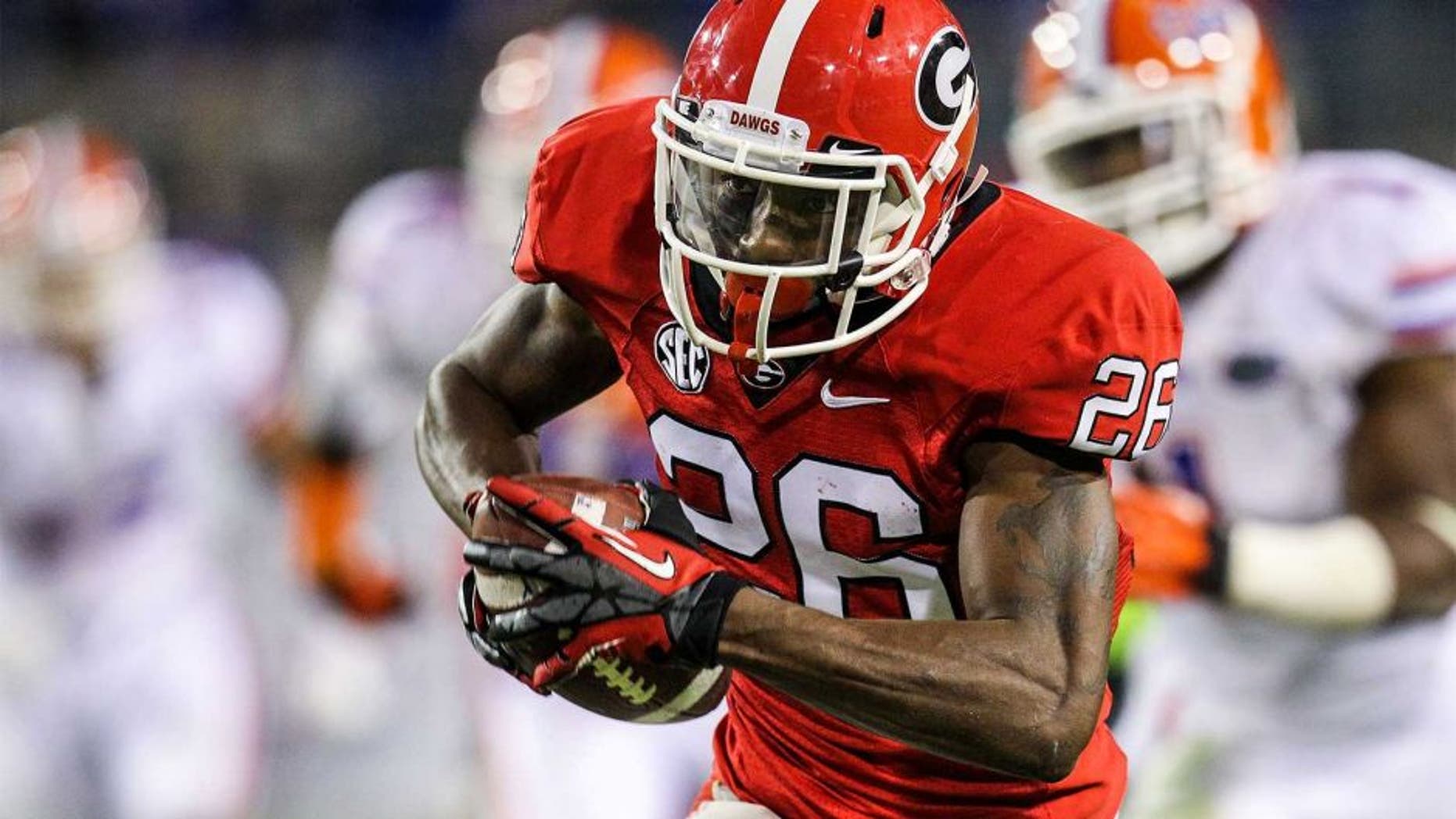Oct 27, 2012; Jacksonville, FL, USA; Georgia Bulldogs cornerback Malcolm Mitchell (26) runs after a catch for a touchdown in the fourth quarter against the Florida Gators at EverBank Field. The Bulldogs won 17-9. Mandatory Credit: Daniel Shirey-USA TODAY Sports