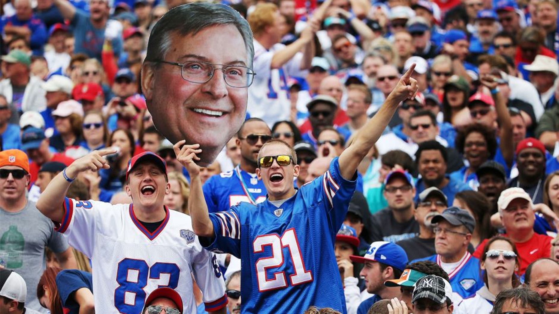 ORCHARD PARK, NY - SEPTEMBER 14: Buffalo Bills fans hold up a picture of Terry Pegula during the first half against the Miami Dolphins at Ralph Wilson Stadium on September 14, 2014 in Orchard Park, New York. (Photo by Tom Szczerbowski/Getty Images)