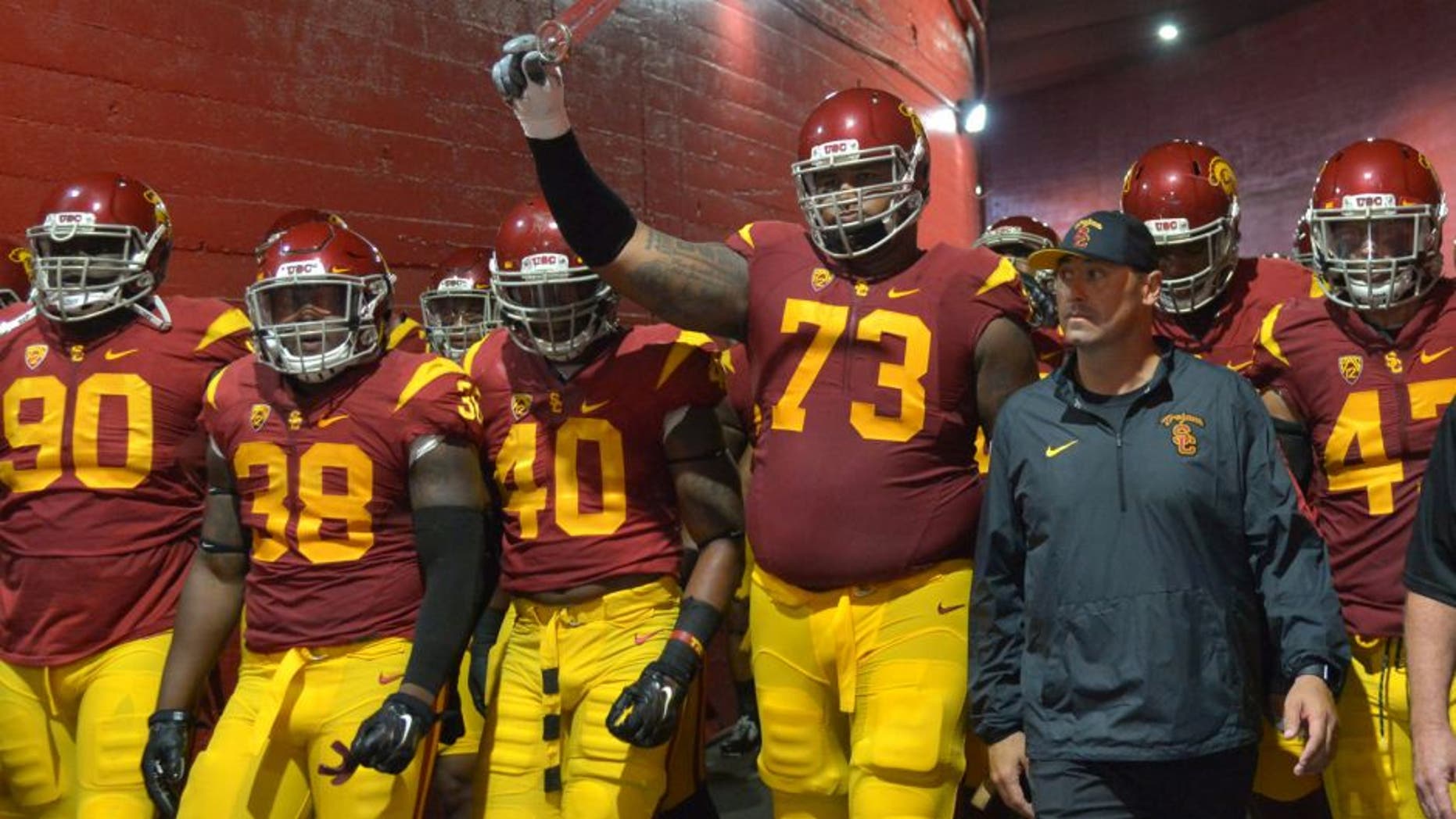 Oct 8, 2015; Los Angeles, CA, USA; Southern California Trojans coach Steve Sarkisian accompanies players onto the field before the game against the Washington Huskies at Los Angeles Memorial Coliseum. Mandatory Credit: Kirby Lee-USA TODAY Sports