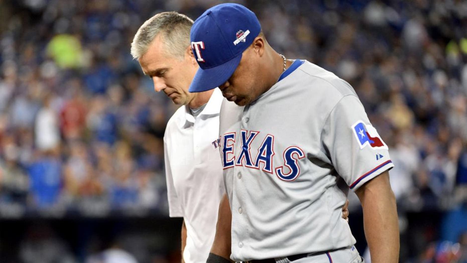 Oct 8, 2015; Toronto, Ontario, CAN; Texas Rangers third baseman Adrian Beltre is helped off the field in the third inning after an injury sustained against the Toronto Blue Jays in game one of the ALDS at Rogers Centre. Mandatory Credit: Nick Turchiaro-USA TODAY Sports