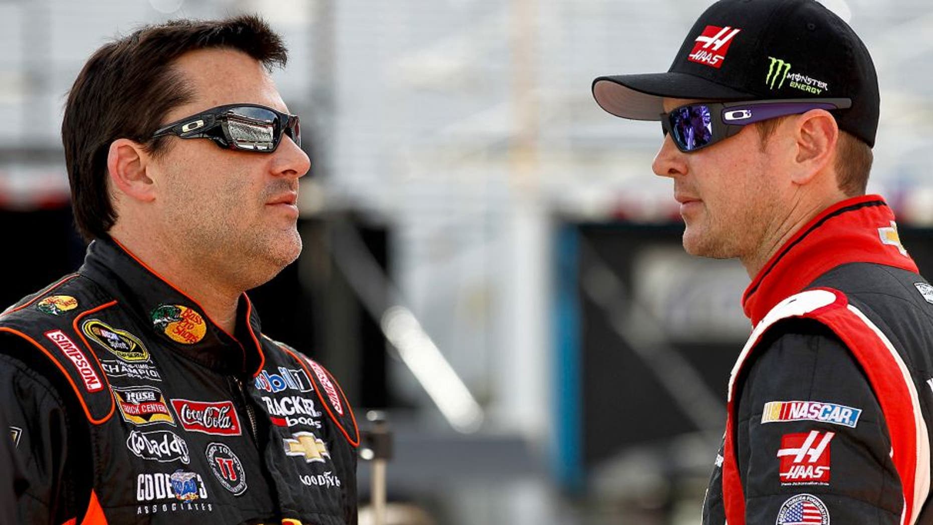 BRISTOL, TN - MARCH 14: Tony Stewart, driver of the #14 Bass Pro Shops / Mobil 1 Chevrolet, talks with Kurt Busch, driver of the #41 Haas Automation Chevrolet, on the grid during qualifying for the NASCAR Sprint Cup Series Food City 500 at Bristol Motor Speedway on March 14, 2014 in Bristol, Tennessee. (Photo by Jeff Zelevansky/NASCAR via Getty Images)