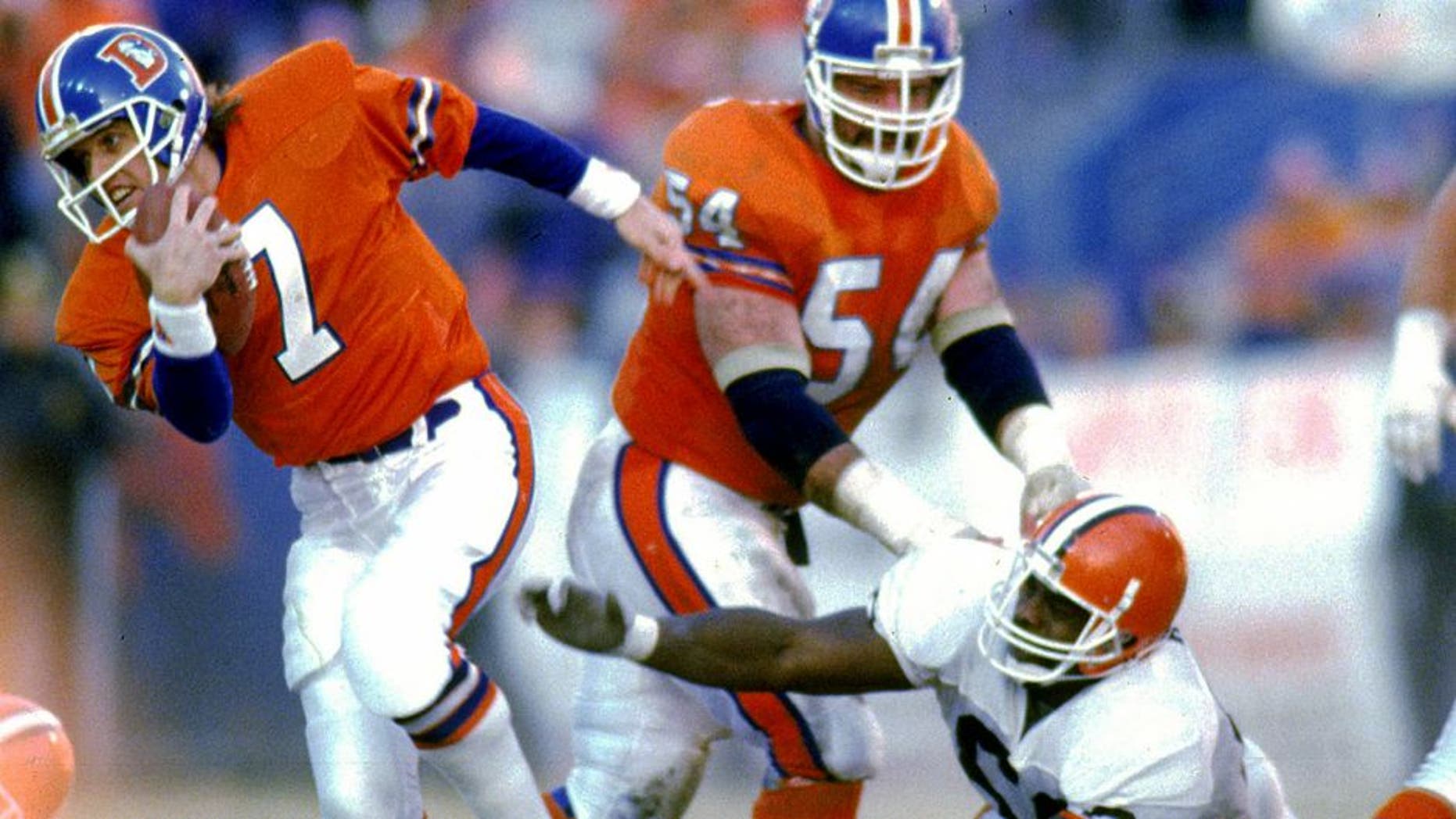 DENVER, CO - JANUARY 17: Quarterback John Elway #7 of the Denver Broncos runs upfield to elude the Cleveland Browns defense in the 1987 AFC Championship Game at Mile High Stadium on January 17, 1988 in Denver, Colorado. The Broncos defeated the Browns 38-33. (Photo by E.L. Bakke/Getty Images)