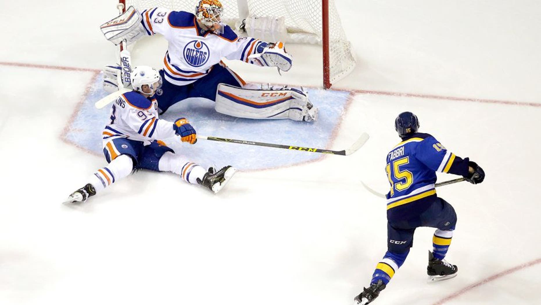 St. Louis Blues' Robby Fabbri, right, scores past Edmonton Oilers goalie Cam Talbot and Ryan Nugent-Hopkins, bottom left, during the third period of an NHL hockey game Thursday, Oct. 8, 2015, in St. Louis. The Blues won 3-1. (AP Photo/Jeff Roberson)