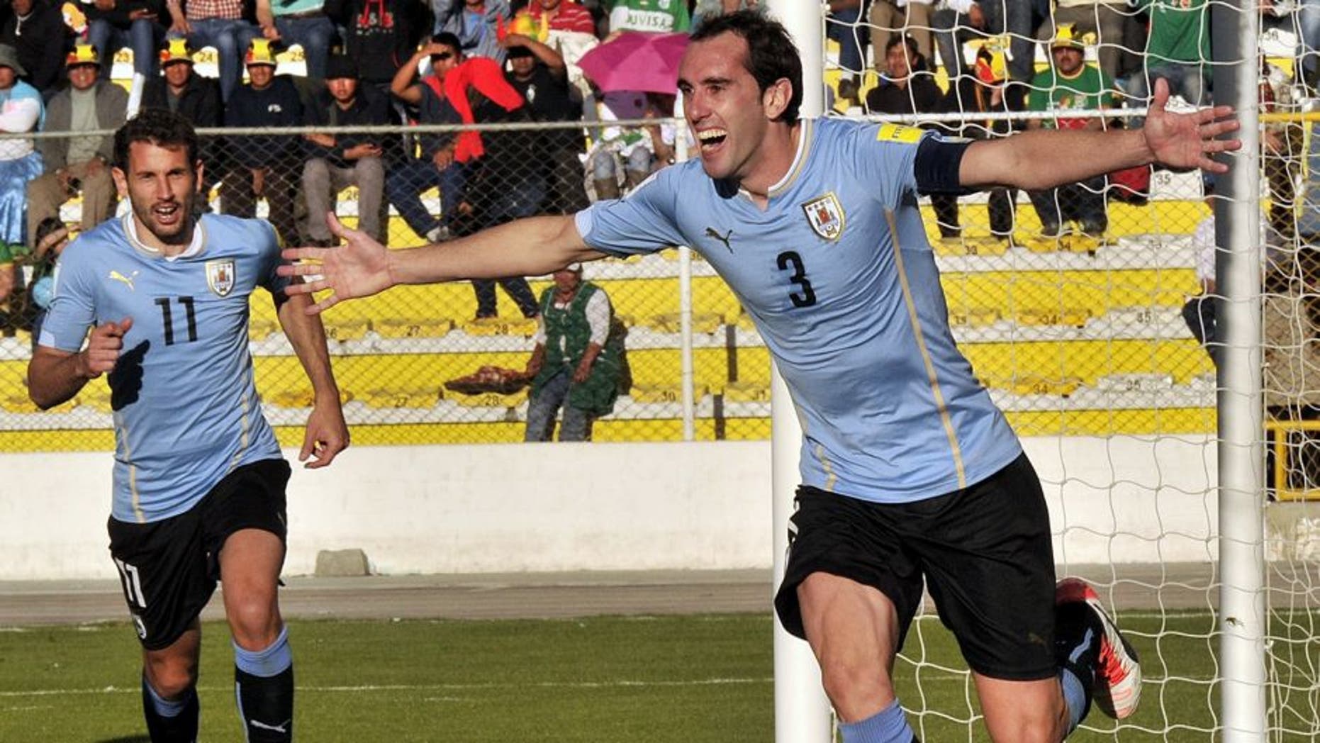Uruguay's defender Diego Godin (R) celebrates after scoring against Bolivia during the Russia 2018 FIFA World Cup qualifiers match, at the Hernando Siles stadium in La Paz, on October 8, 2015. AFP PHOTO / AIZAR RALDES (Photo credit should read AIZAR RALDES/AFP/Getty Images)