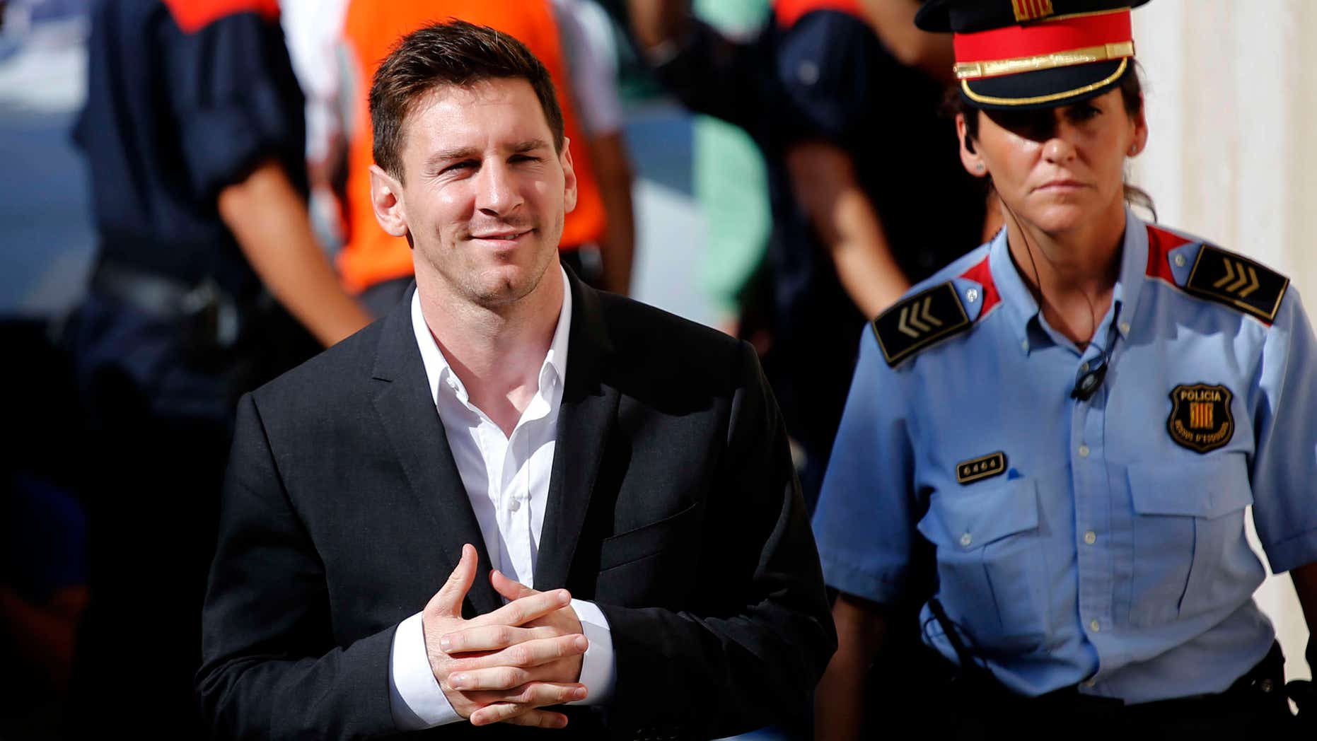 FILE - In this Sept. 27, 2013 file photo, FC Barcelona star Lionel Messi, left, arrives at a court to answer questions in a tax fraud case in Gava, near Barcelona, Spain.