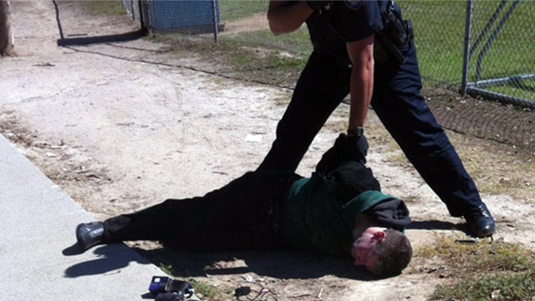 Oct 8: A bystander helps restrain Brendan L. O'Rourke, a suspect in shooting at a school in Carlsbad, Calif.