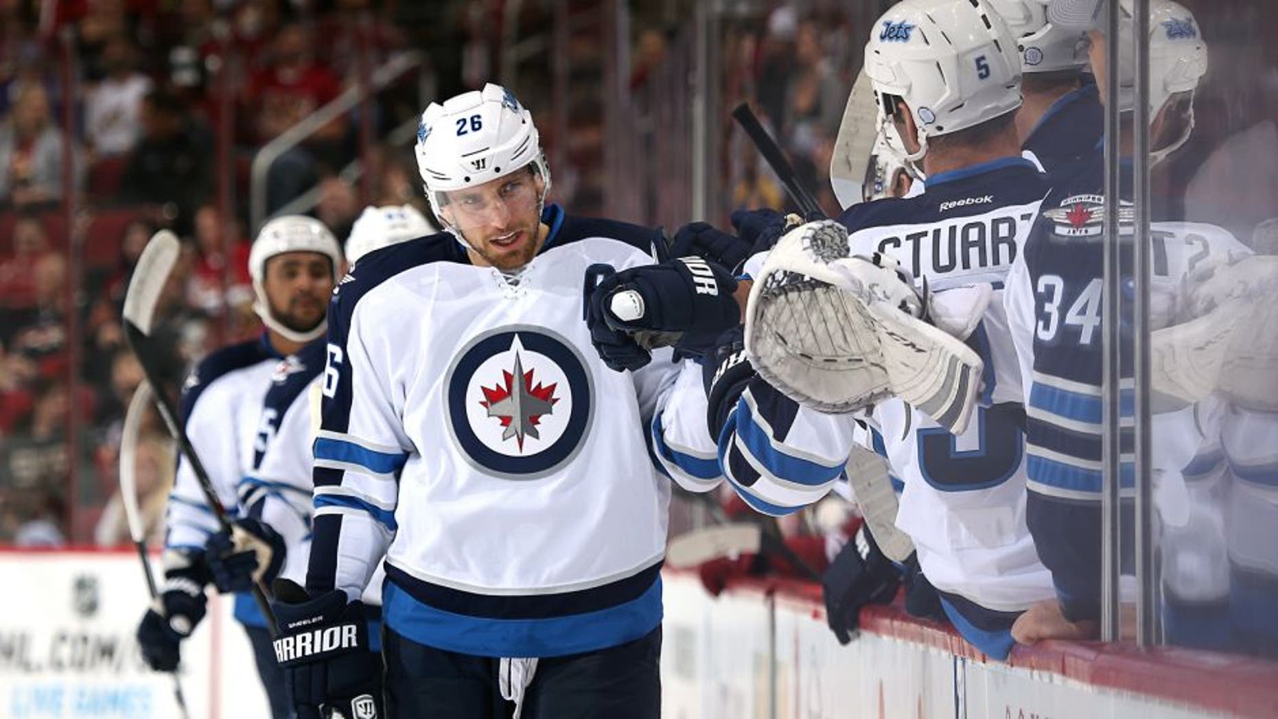 GLENDALE, AZ - OCTOBER 09: Blake Wheeler #26 of the Winnipeg Jets celebrates with teammates on the bench after scoring a first period goal against the Arizona Coyotes during the NHL game at Gila River Arena on October 9, 2014 in Glendale, Arizona. (Photo by Christian Petersen/Getty Images)
