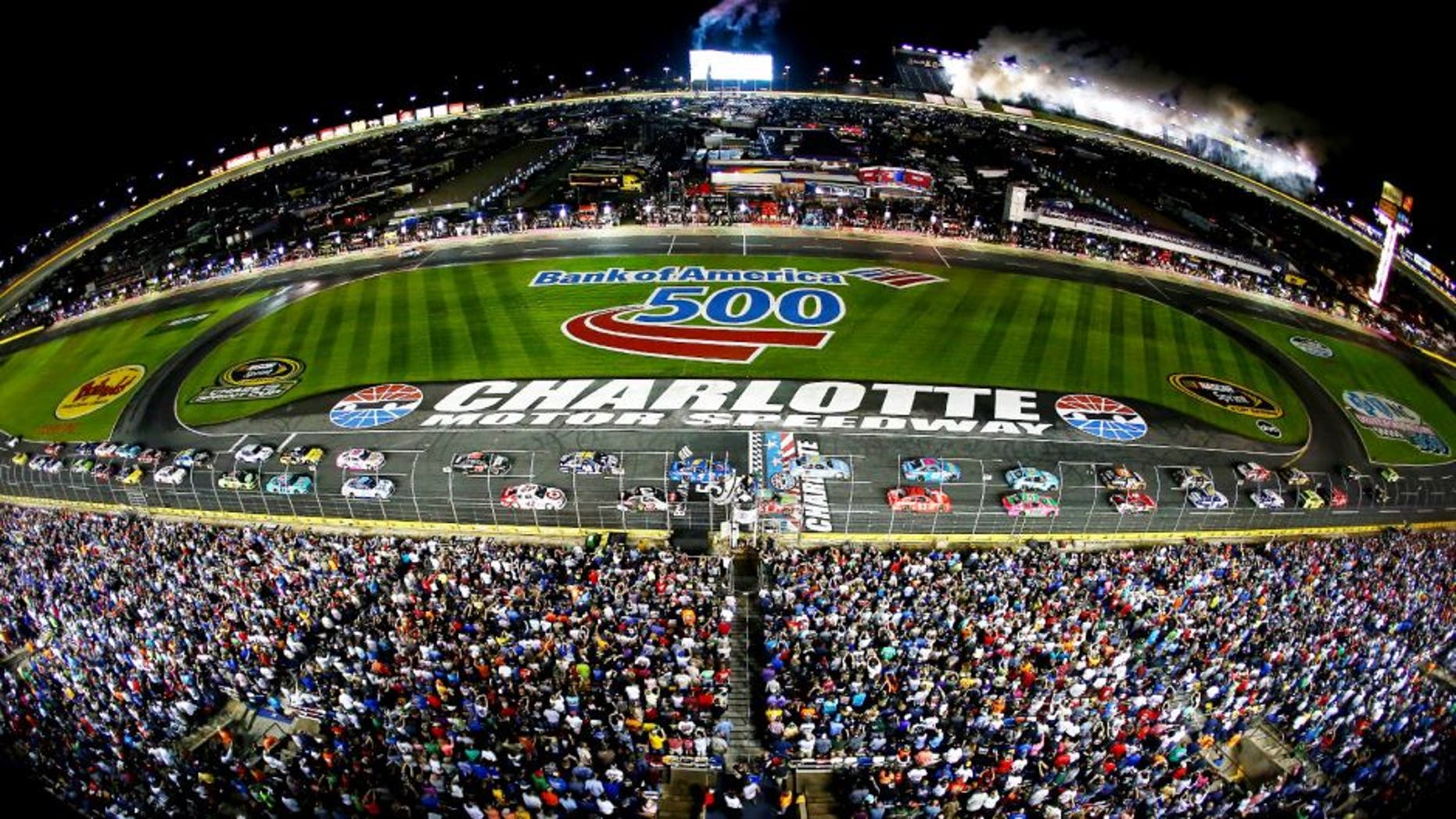 CHARLOTTE, NC - OCTOBER 11: Kyle Busch, driver of the #18 Doublemint Toyota, and Jeff Gordon, driver of the #24 Drive To End Hunger Chevrolet, lead the field to the green flag for the running of the NASCAR Sprint Cup Series Bank of America 500 at Charlotte Motor Speedway on October 11, 2014 in Charlotte, North Carolina. (Photo by Streeter Lecka/Getty Images)