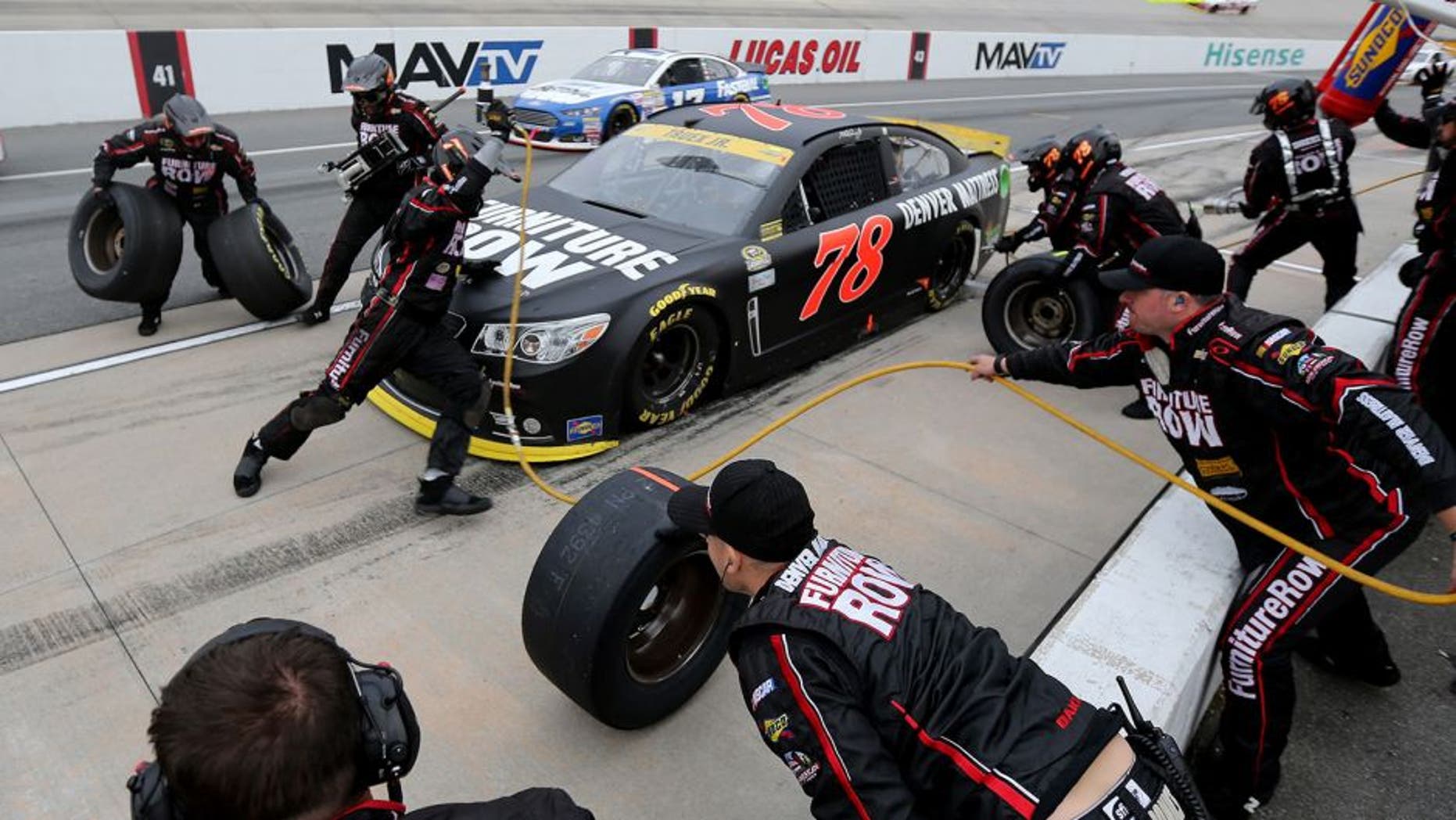 DOVER, DE - OCTOBER 04: Martin Truex Jr., driver of the #78 Furniture Row/Visser Precision Chevrolet, pits during the NASCAR Sprint Cup Series AAA 400 at Dover International Speedway on October 4, 2015 in Dover, Delaware. (Photo by Jerry Markland/Getty Images)