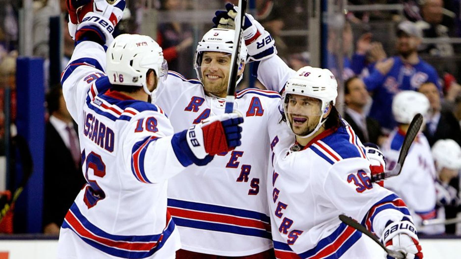 New York Rangers' Mats Zuccarello, right, celebrates his goal against the Columbus Blue Jackets with teammates Derick Brassard, left, and Dan Girardi during the third period of an NHL hockey game Friday, Oct. 9, 2015, in Columbus, Ohio. The Rangers beat the Blue Jackets 4-2. (AP Photo/Jay LaPrete)