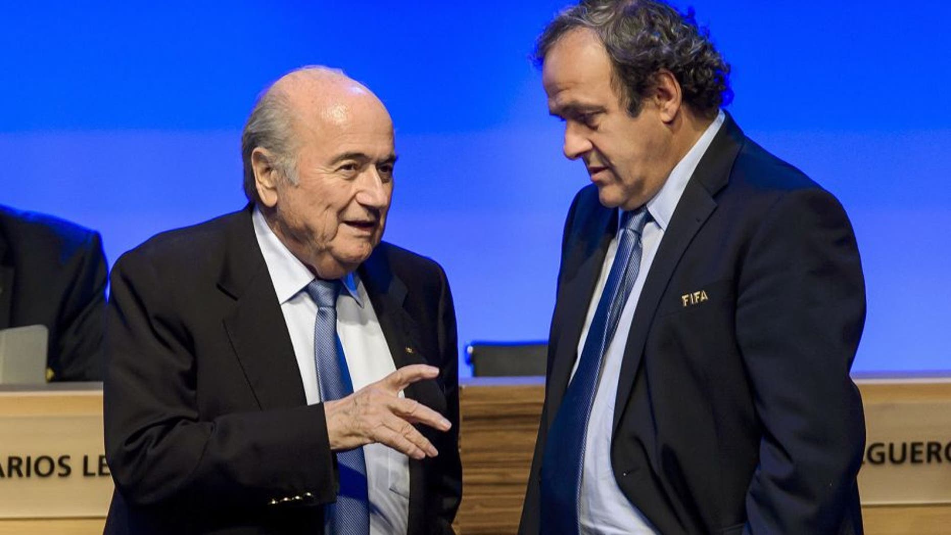 FIFA president Joseph Blatter talks to UEFA president Michel Platini during the 64th FIFA congress on June 11, 2014 in Sao Paulo, on the eve of the opening match of the 2014 FIFA World Cup in Brazil. AFP PHOTO / FABRICE COFFRINI (Photo credit should read FABRICE COFFRINI/AFP/Getty Images)