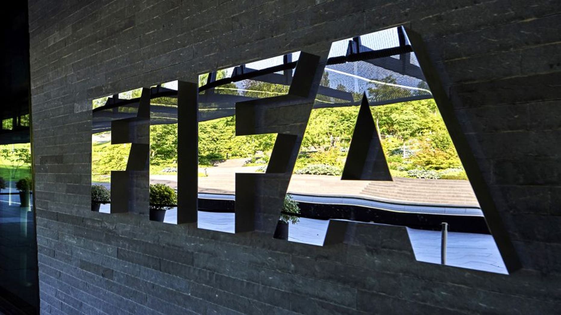FIFA employees enter at the FIFA headquarters on June 3, 2015 in Zurich. Blatter resigned on June 2, 2015 as president of FIFA as a mounting corruption scandal engulfed world football's governing body. The 79-year-old Swiss official, FIFA president for 17 years and only reelected on May 29, said a special congress would be called as soon as possible to elect a successor. AFP PHOTO / MICHAEL BUHOLZER (Photo credit should read MICHAEL BUHOLZER/AFP/Getty Images)