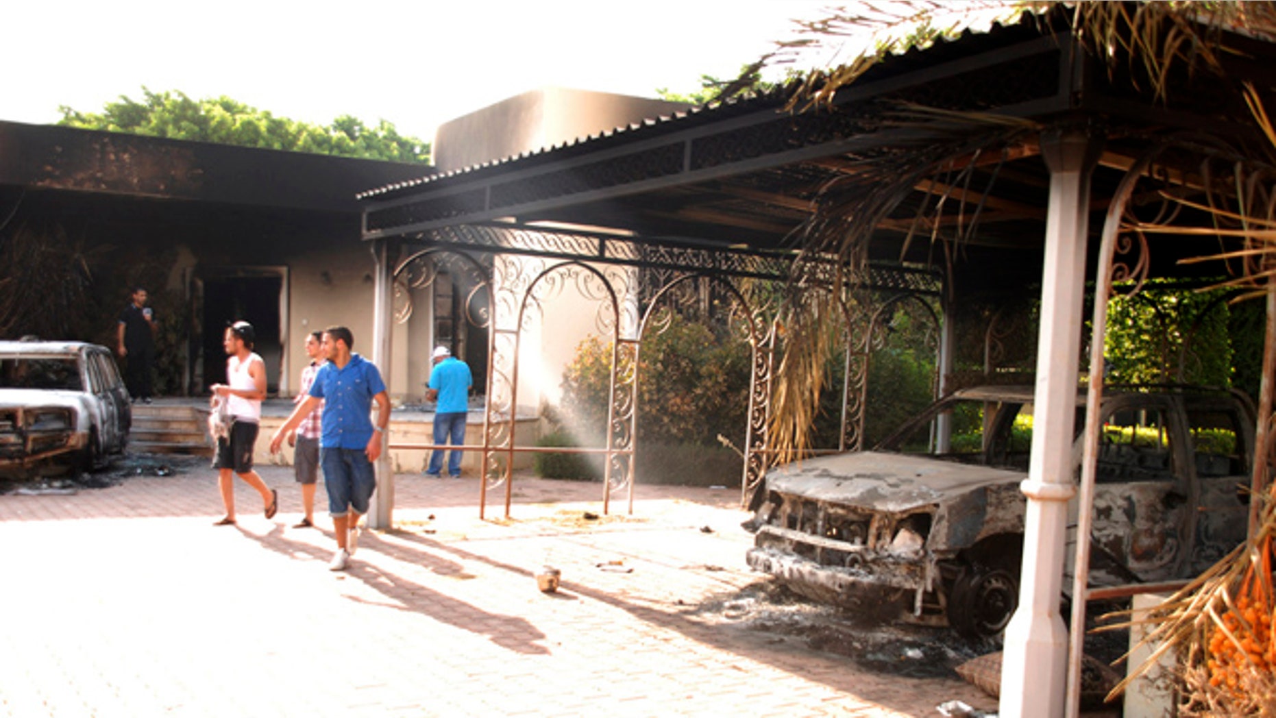 Sept. 12, 2012: Libyans walk on the grounds of the gutted U.S. consulate in Benghazi, Libya, after an attack that killed four Americans, including Ambassador Chris Stevens.