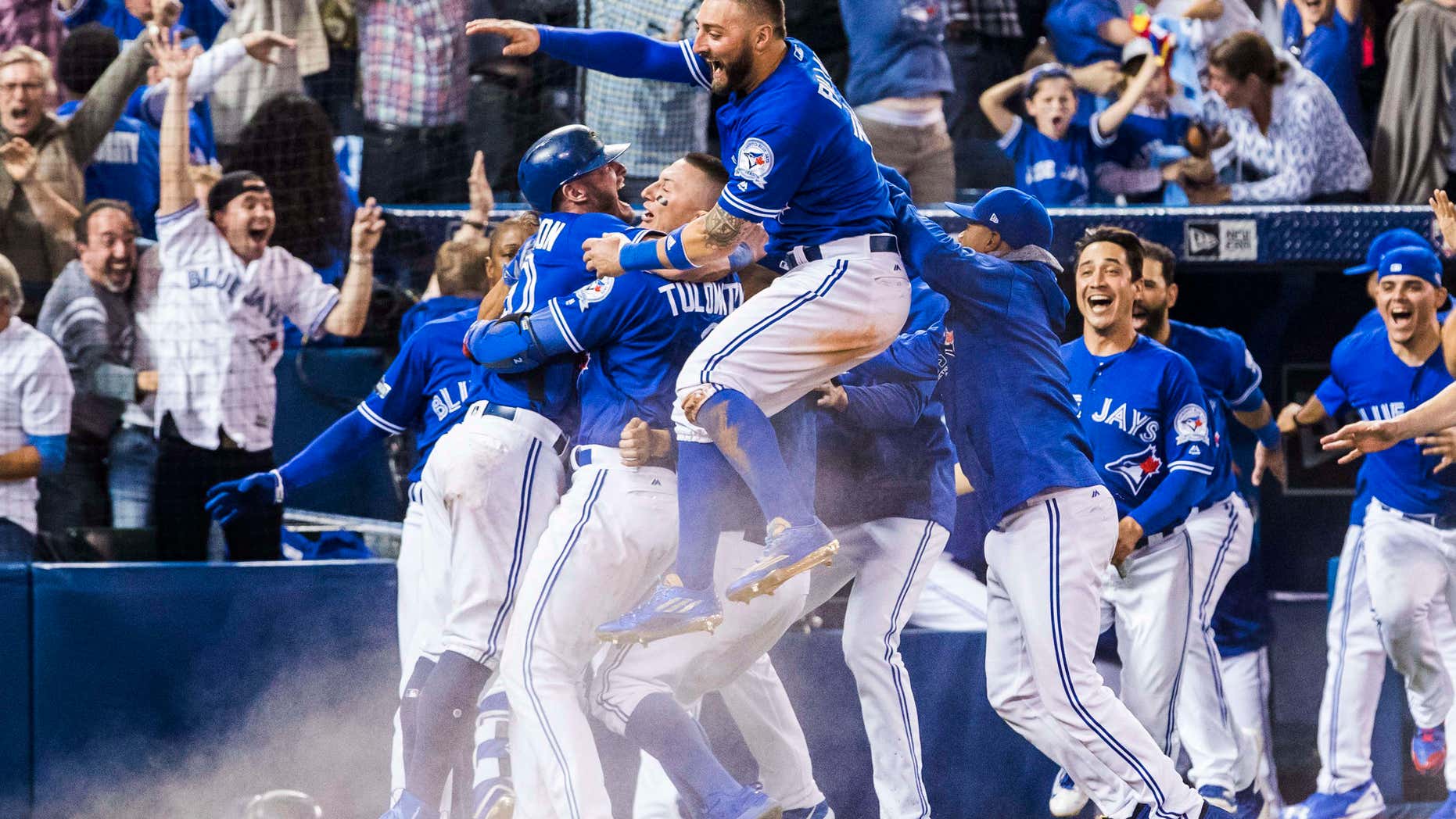 Oct. 9, 2016: Toronto Blue Jays players celebrate their walk-off win to eliminate the Texas Rangers during the tenth inning to win the American League Division Series in Toronto.