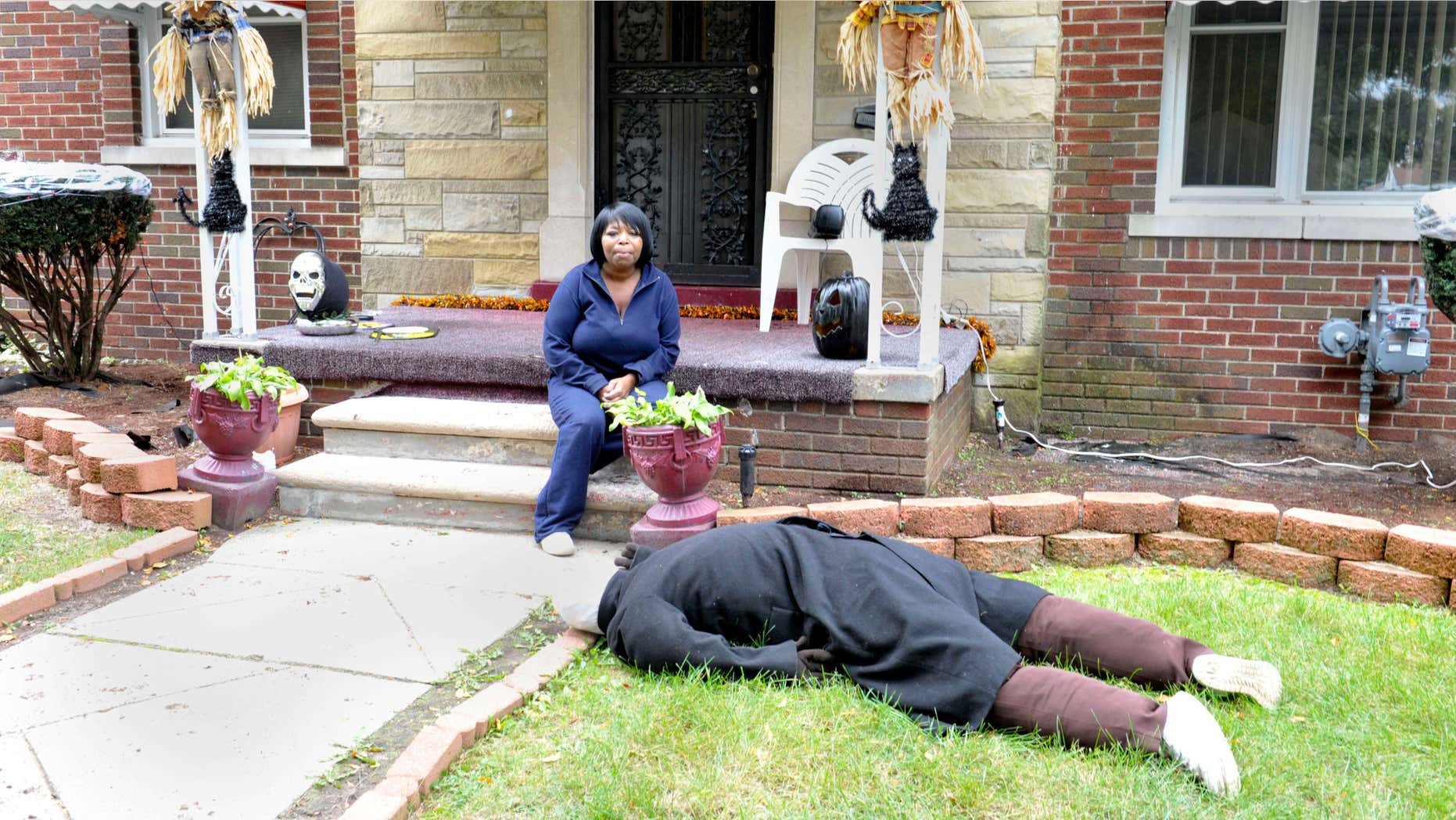 Oct. 9, 2015: Jeannine Haddon poses on the porch of her Halloween decorated home in Detroit.