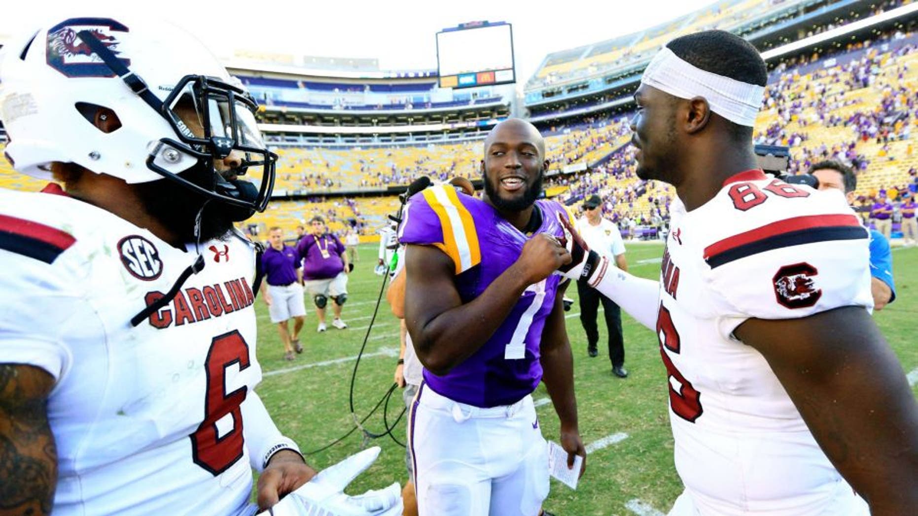 Oct 10, 2015; Baton Rouge, LA, USA; LSU Tigers running back Leonard Fournette (7) talks to South Carolina Gamecocks tight end Kevin Crosby (86) and safety Chris Moody (6) following road game at Tiger Stadium. LSU defeated South Carolina 45-24. Mandatory Credit: Derick E. Hingle-USA TODAY Sports